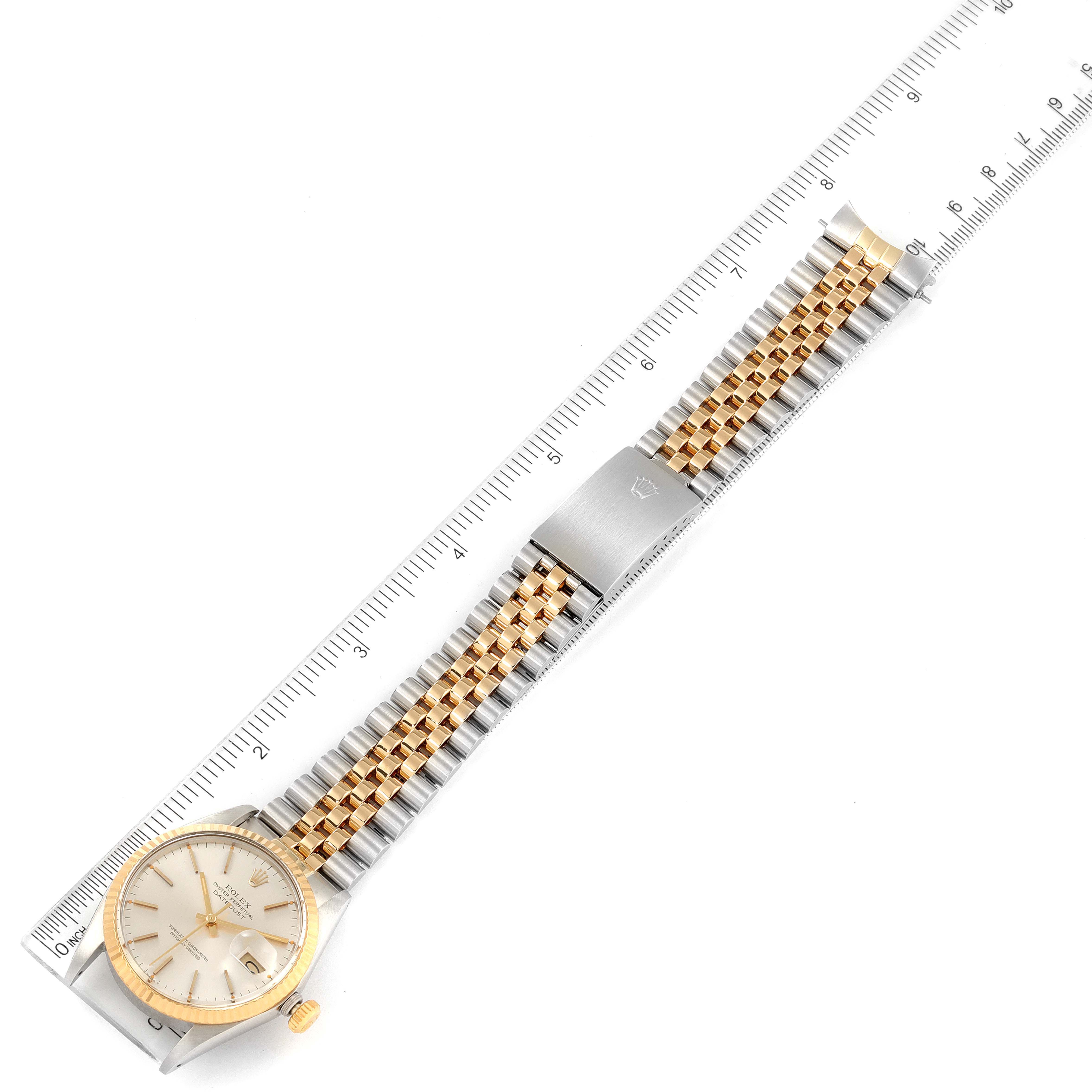 The Rolex Vintage Collection 16013 Men's Steel and Gold (two tone) Silver Dial 16013 Men's Steel and Gold (two tone) Silver Dial watch is laid flat with a ruler, showing its face, bracelet, and clasp.