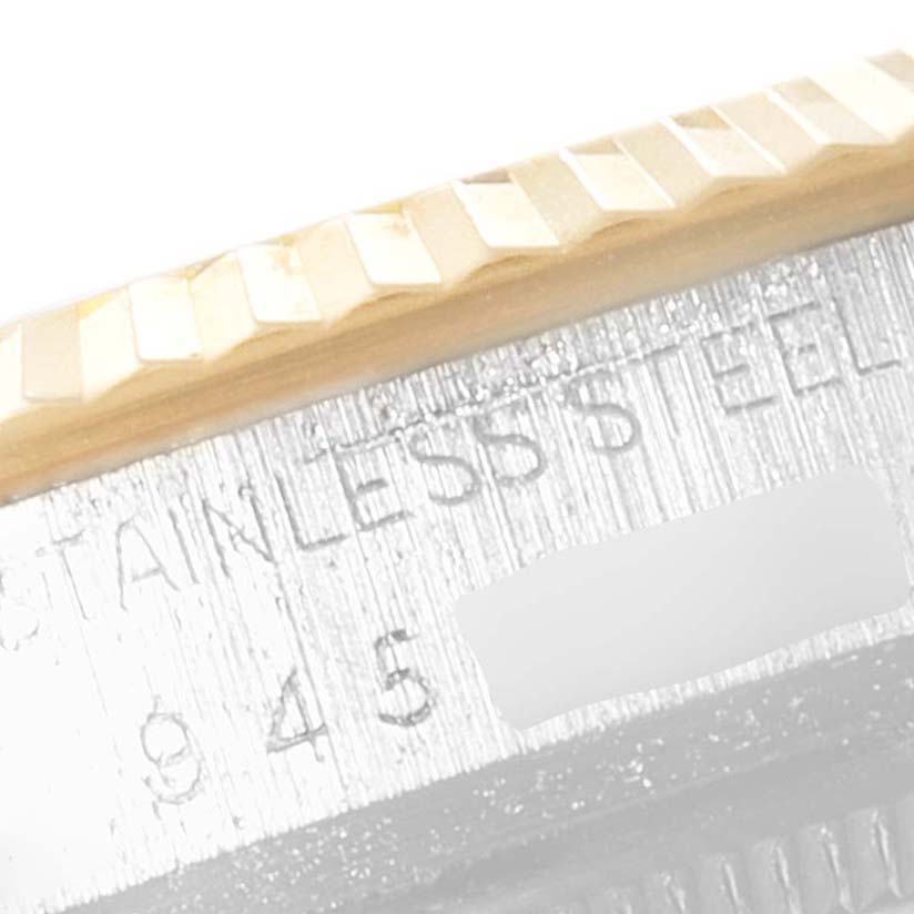 This is a macro shot of the bezel and part of the case, showcasing the "Vintage Collection" model by Rolex.