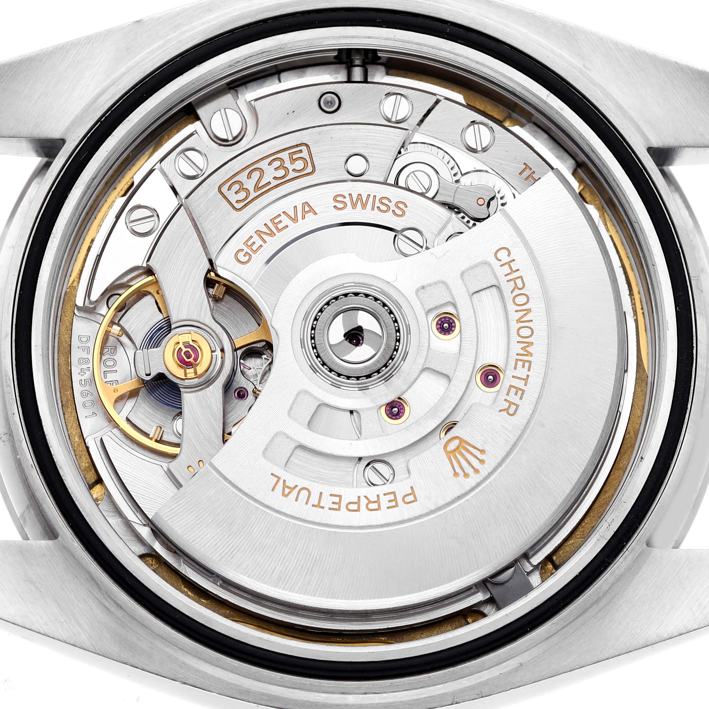 The image shows the movement mechanism of a Rolex Datejust 41 126300 Men's Stainless Steel White Dial, featuring the rotor and intricate inner components.