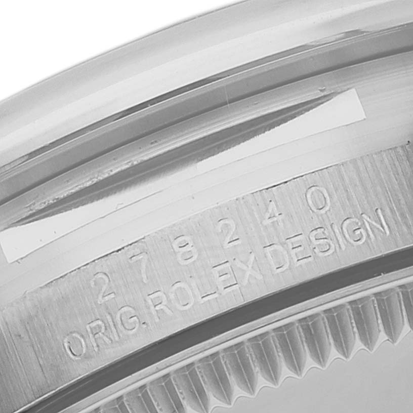 The image shows a close-up of the serial number and "ORIG. ROLEX DESIGN" engraving on the bezel of a Mid-Size Rolex watch.