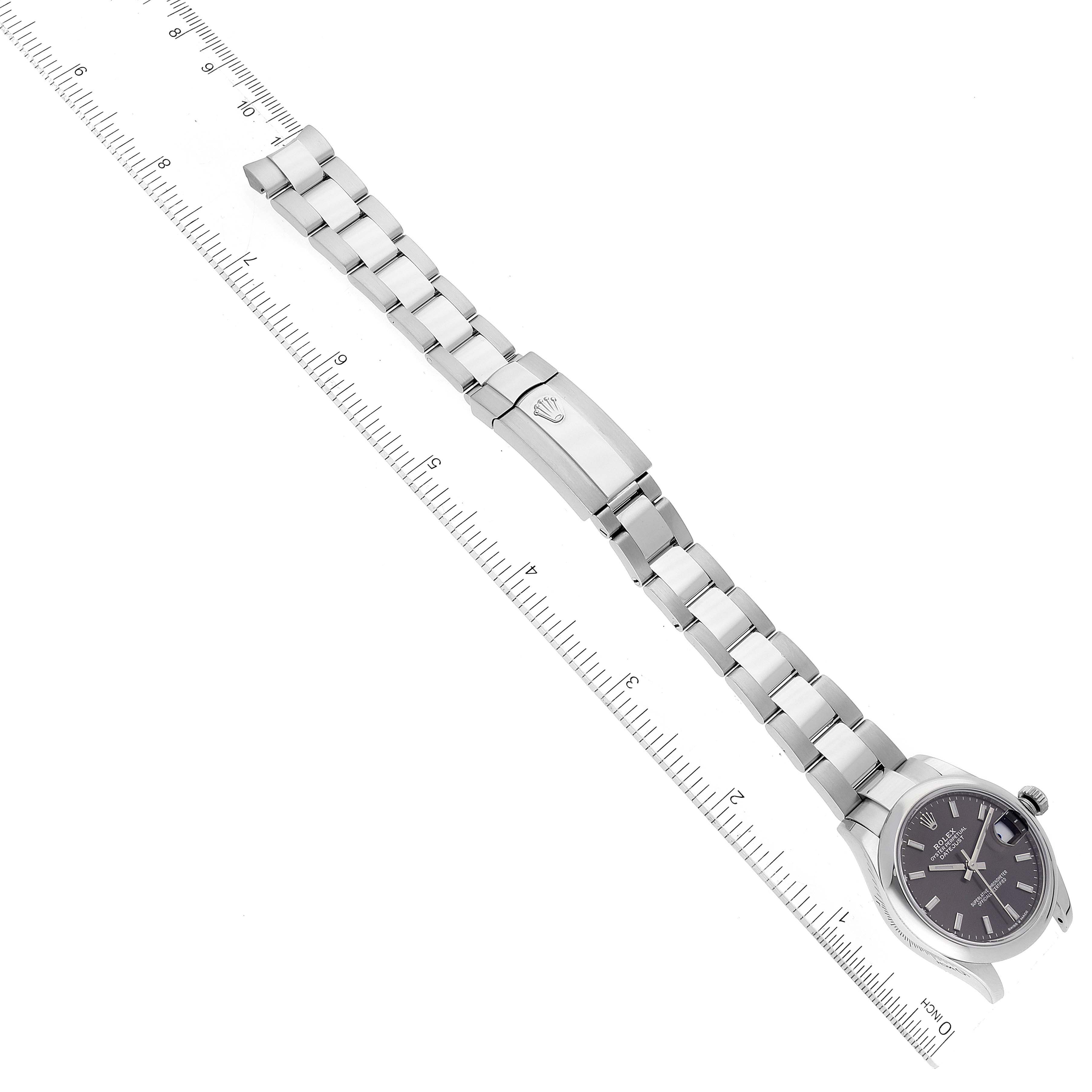 The image shows a Rolex Mid-Size 278240 Women's Stainless Steel Grey Dial 278240 Women's Stainless Steel Grey Dial model watch placed horizontally with focus on its bracelet and partially on the watch face, alongside a ruler for scale.