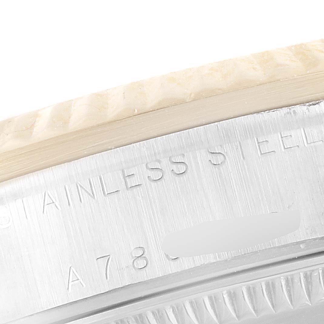 The image shows a close-up angle of the bezel and engraved text on the case of a Mid-Size Rolex watch.