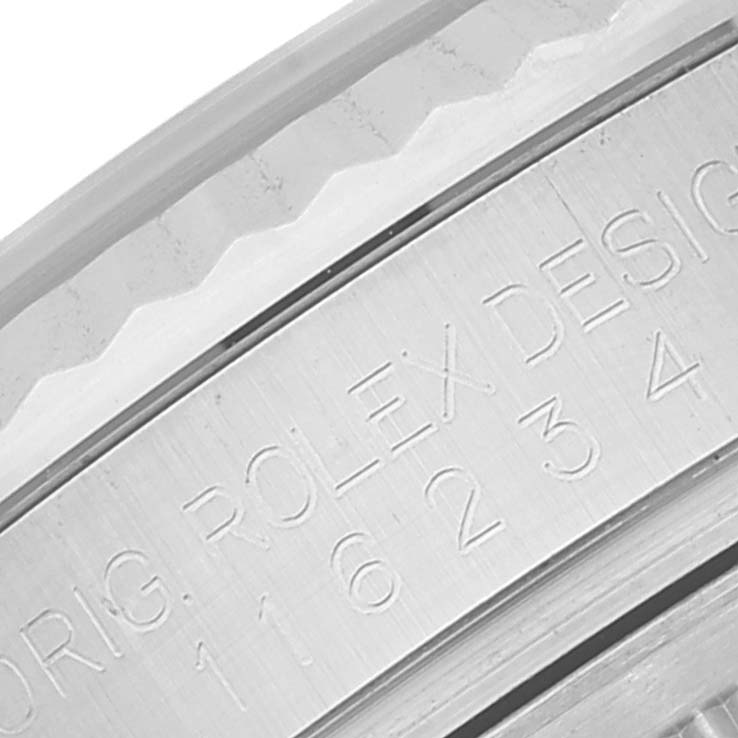 The image shows a close-up of the engraved bezel and serial number on a Rolex Datejust 116234 Men's Stainless Steel Blue Dial 116234 Men's Stainless Steel Blue Dial watch.