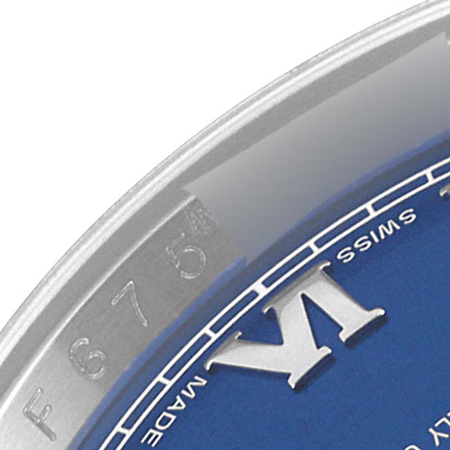 The image shows a close-up of the dial and edge of the case of a Rolex Datejust 116234 Men's Stainless Steel Blue Dial 116234 Men's Stainless Steel Blue Dial watch, featuring Roman numerals and part of the serial number.