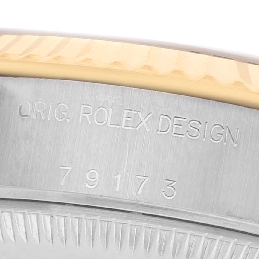 The image shows a close-up of the Rolex Datejust 79173 Women's Steel and Gold (two tone) Champagne Dial model's case edge, featuring "Orig. Rolex Design" and the reference number.