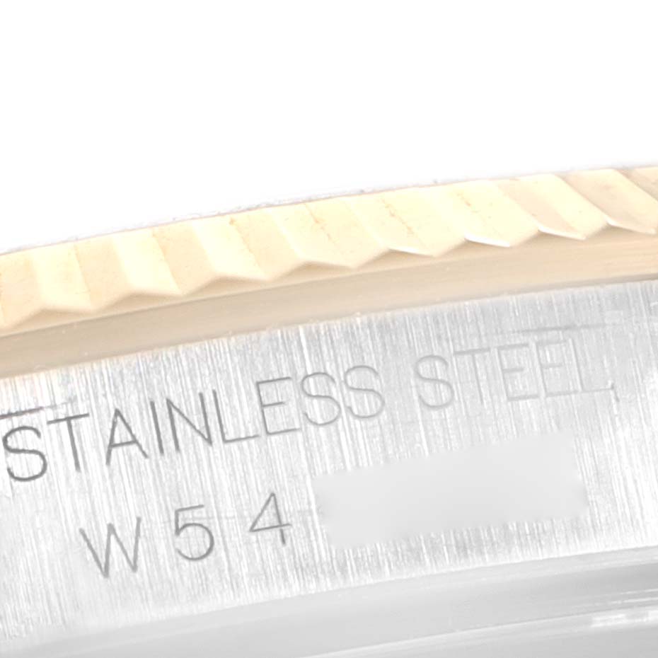 This close-up image shows the stainless steel engraving and part of the fluted bezel of the Rolex Datejust 16233 Men's Steel and Gold (two tone) Champagne Dial 16233 Men's Steel and Gold (two tone) Champagne Dial watch.