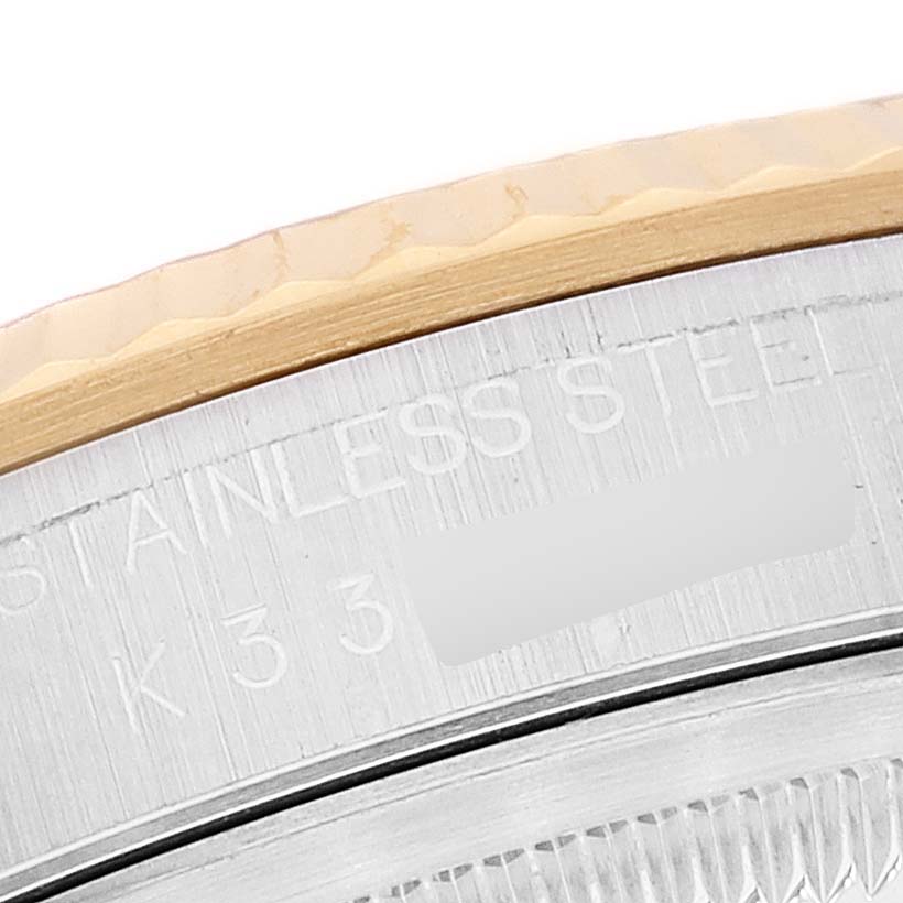 This image shows a close-up of the bezel, part of the case, and some text on a Rolex Datejust 16233 Men's Steel and Gold (two tone) Silver Dial 16233 Men's Steel and Gold (two tone) Silver Dial watch.