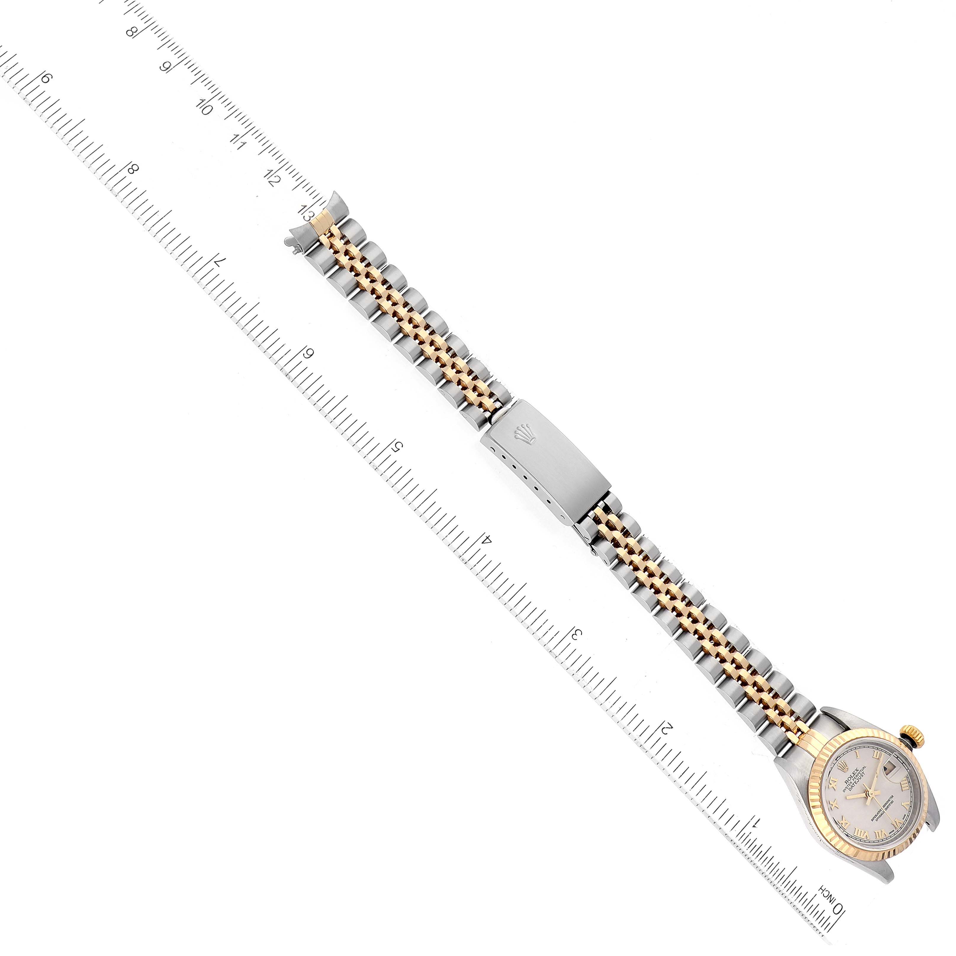 The image shows a Rolex Datejust 79173 Women's Steel and Gold (two tone) Beige Dial 79173 Women's Steel and Gold (two tone) Beige Dial watch laid flat with its bracelet extended, next to a ruler for measurement.