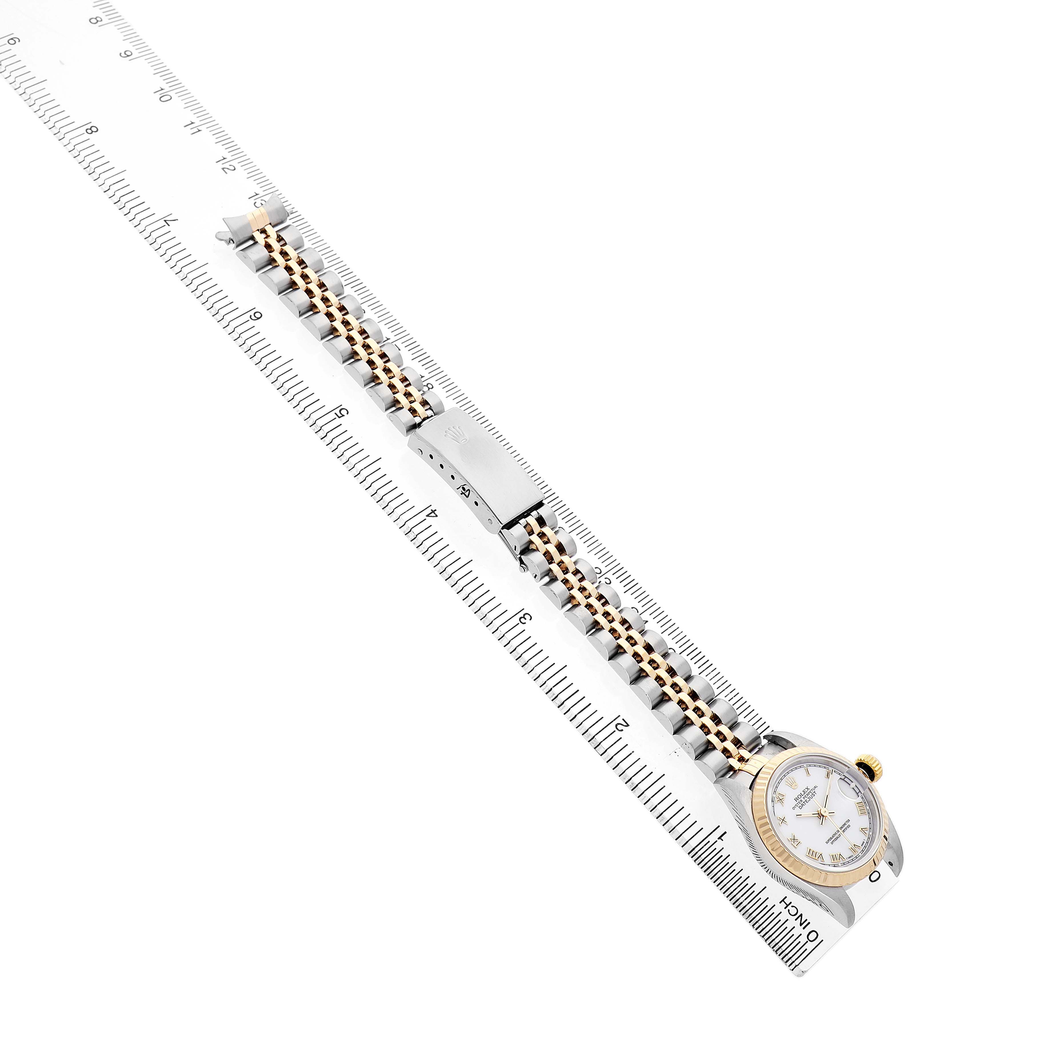 The Rolex Datejust 69173 Women's Steel and Gold (two tone) Yellow Dial is displayed from a top-down angle, showing the watch face, bracelet, and clasp alongside a ruler for scale.