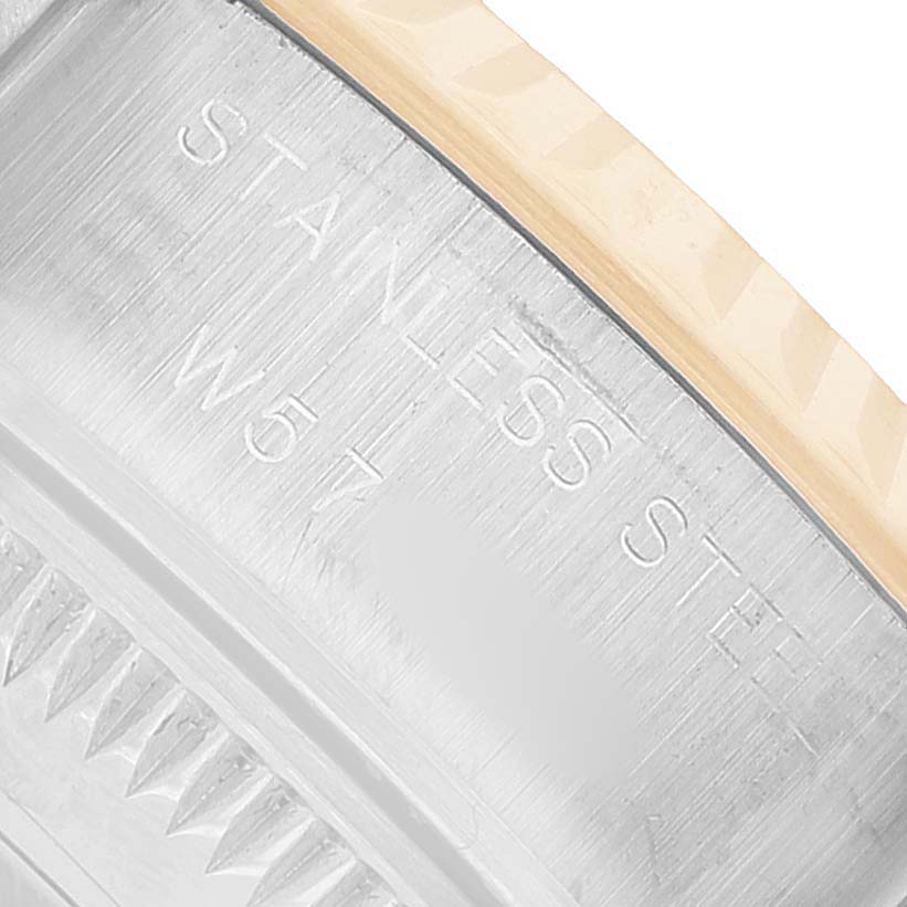 The image shows an angled close-up of the stainless steel case back of a Rolex Datejust 69173 Women's Steel and Gold (two tone) Yellow Dial watch, highlighting engravings.