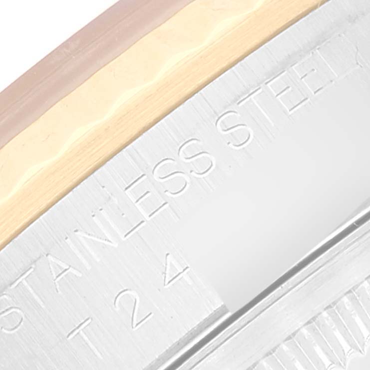 This image shows a close-up of the side engraving and part of the bezel of a Rolex Datejust 16233 Men's Steel and Gold (two tone) White Dial 16233 Men's Steel and Gold (two tone) White Dial watch.