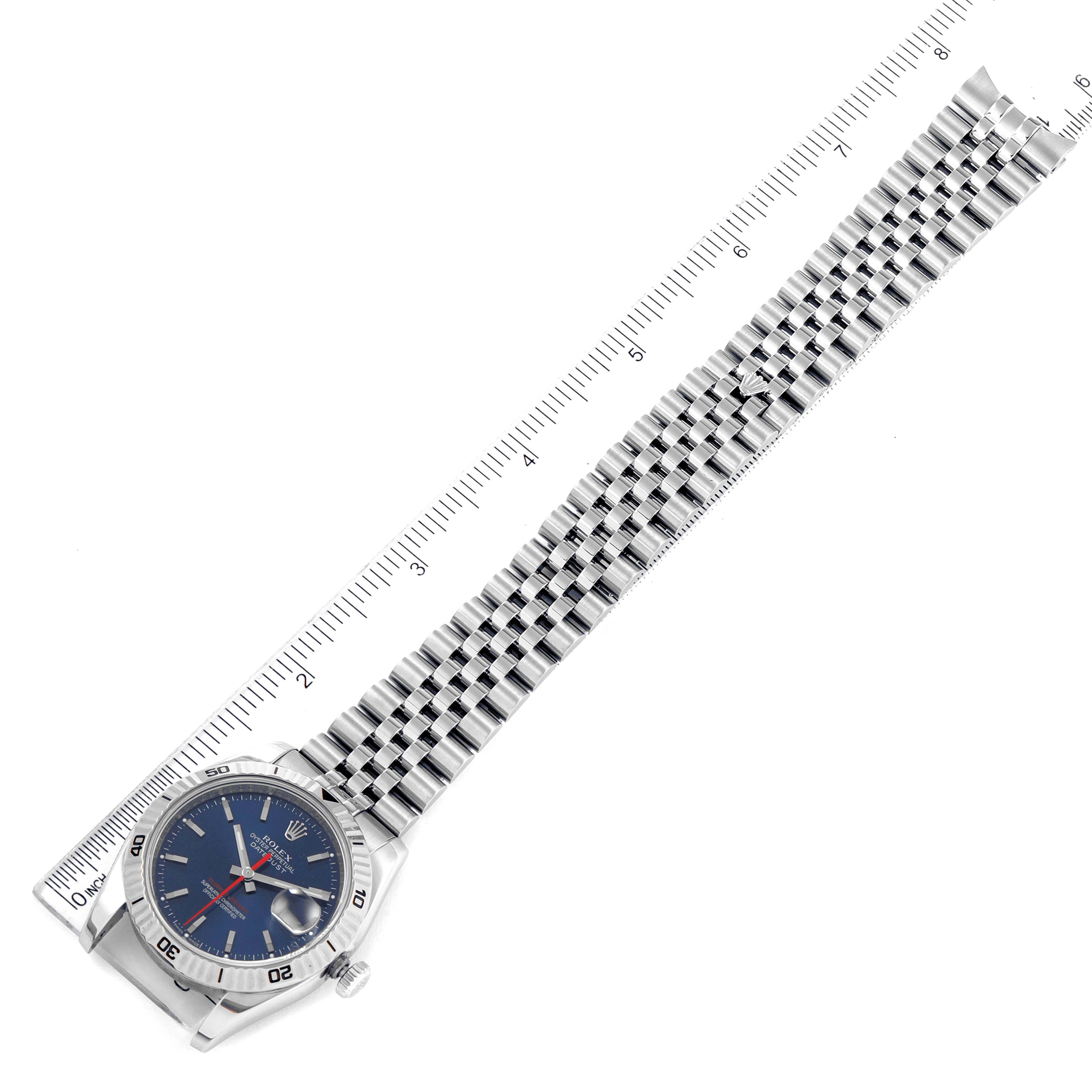 The image shows a Rolex Turn-o-Graph 116264 Men's Stainless Steel Blue Dial 116264 Men's Stainless Steel Blue Dial watch at an overhead angle, displaying the face, bezel, and full length of the bracelet alongside a ruler.