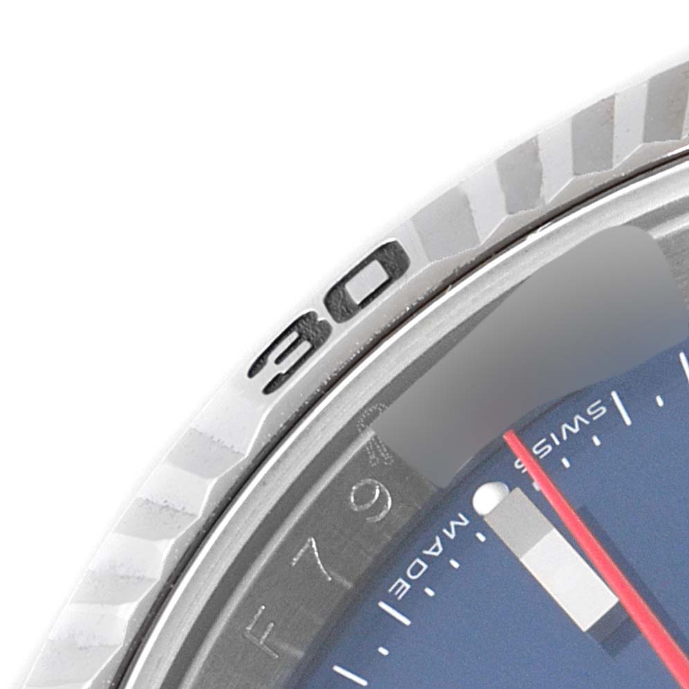 The image shows a close-up of the bezel and part of the dial of a Rolex Turn-o-Graph 116264 Men's Stainless Steel Blue Dial 116264 Men's Stainless Steel Blue Dial watch.