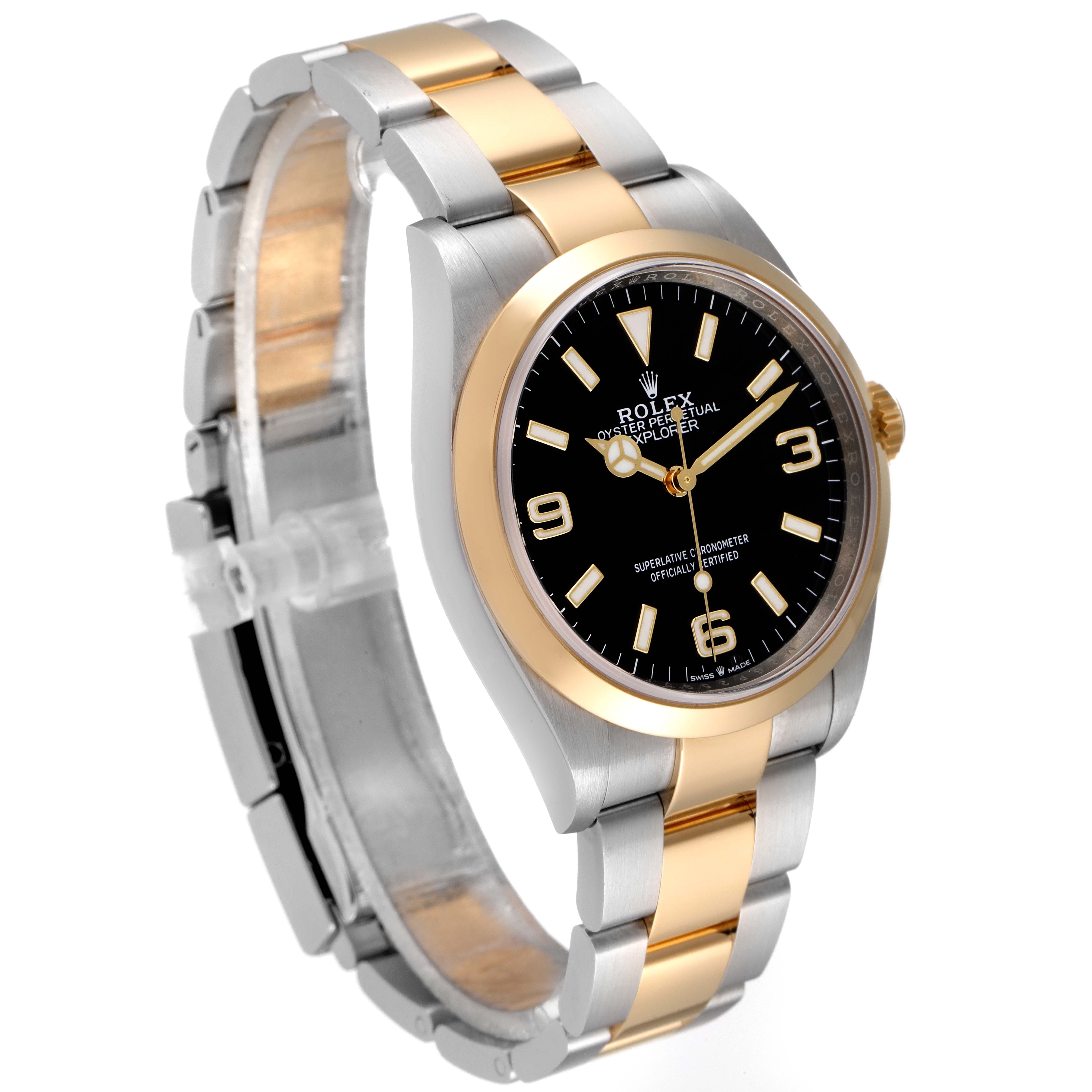 This image shows a Rolex Explorer 124273 Men's Steel and Gold (two tone) Black Dial 124273 Men's Steel and Gold (two tone) Black Dial watch angled to display its black dial, gold bezel, and two-tone metal bracelet.