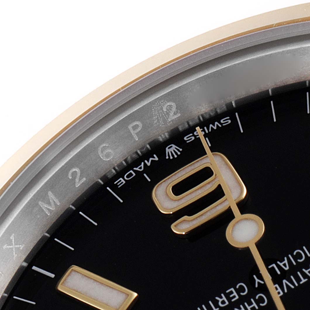 This image shows a close-up of the dial and bezel of a Rolex Explorer 124273 Men's Steel and Gold (two tone) Black Dial 124273 Men's Steel and Gold (two tone) Black Dial watch, focusing on the numeral "9" and "Swiss Made" text.