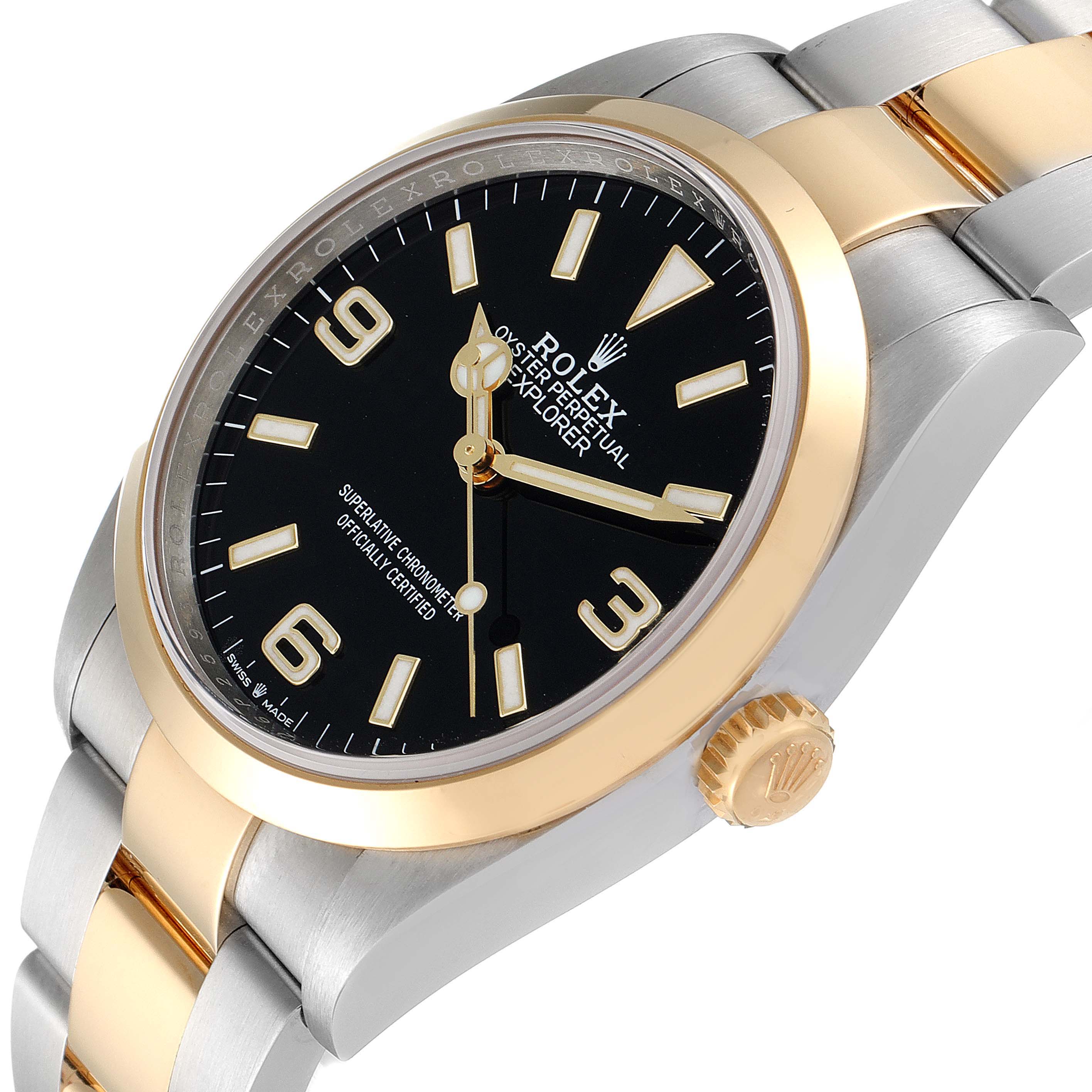 The image shows a close-up angle of a Rolex Explorer 124273 Men's Steel and Gold (two tone) Black Dial 124273 Men's Steel and Gold (two tone) Black Dial watch, highlighting the black dial, gold bezel, and part of the bracelet.