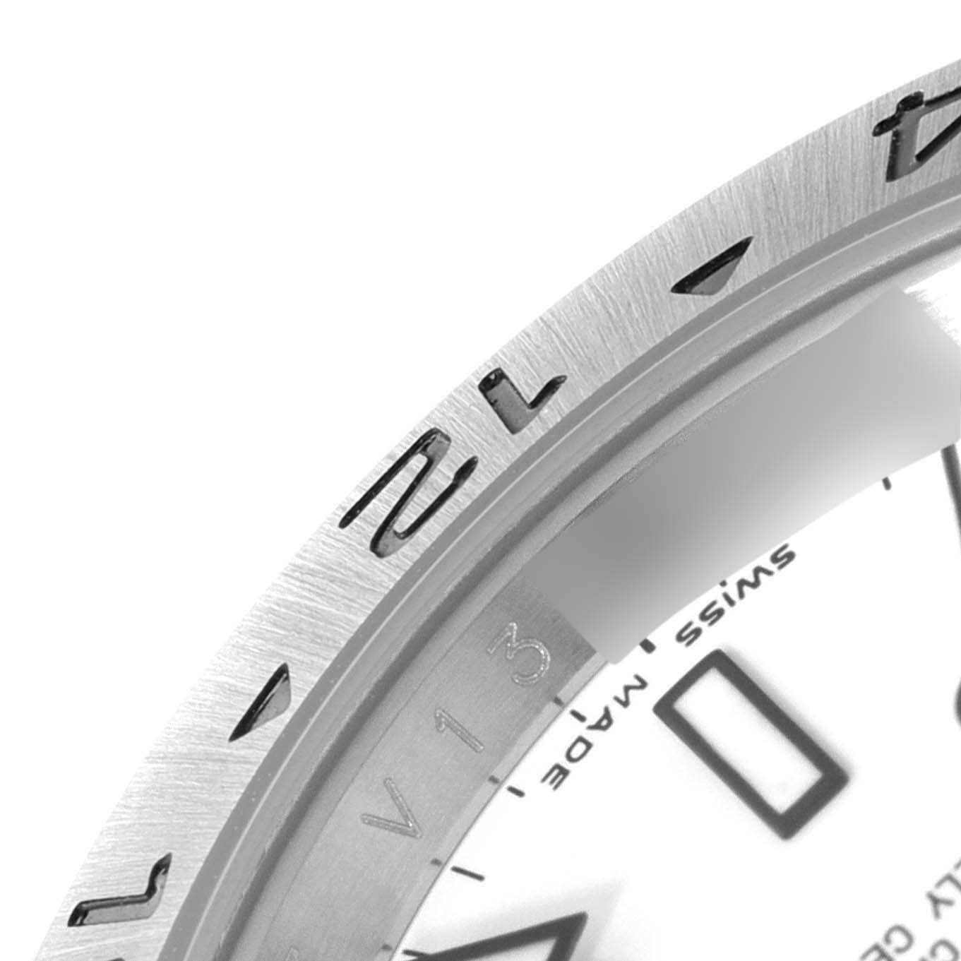 This close-up angle shows a portion of the Rolex Explorer 16570 Men's Stainless Steel White Dial 16570 Men's Stainless Steel White Dial's bezel and part of the dial.