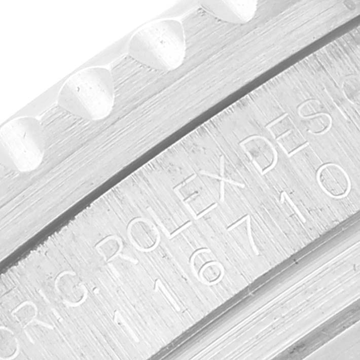 The image shows a close-up of the inscription and edge of the bezel for a Rolex GMT-Master 116710 Men's Stainless Steel Black Dial 116710 Men's Stainless Steel Black Dial watch.