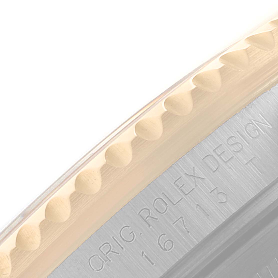 This close-up image shows part of the engraved case back and the edge of the bezel of a Rolex GMT-Master 16713 Men's Steel and Gold (two tone) Brown Dial 16713 Men's Steel and Gold (two tone) Brown Dial watch.