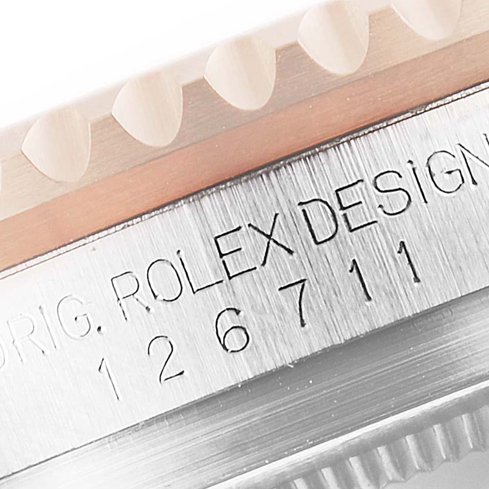 This close-up image shows the side of a Rolex GMT-Master 126711CHNR Men's Steel and Gold (two tone) Black Dial 126711CHNR Men's Steel and Gold (two tone) Black Dial watch, highlighting its bezel and engraved model number.