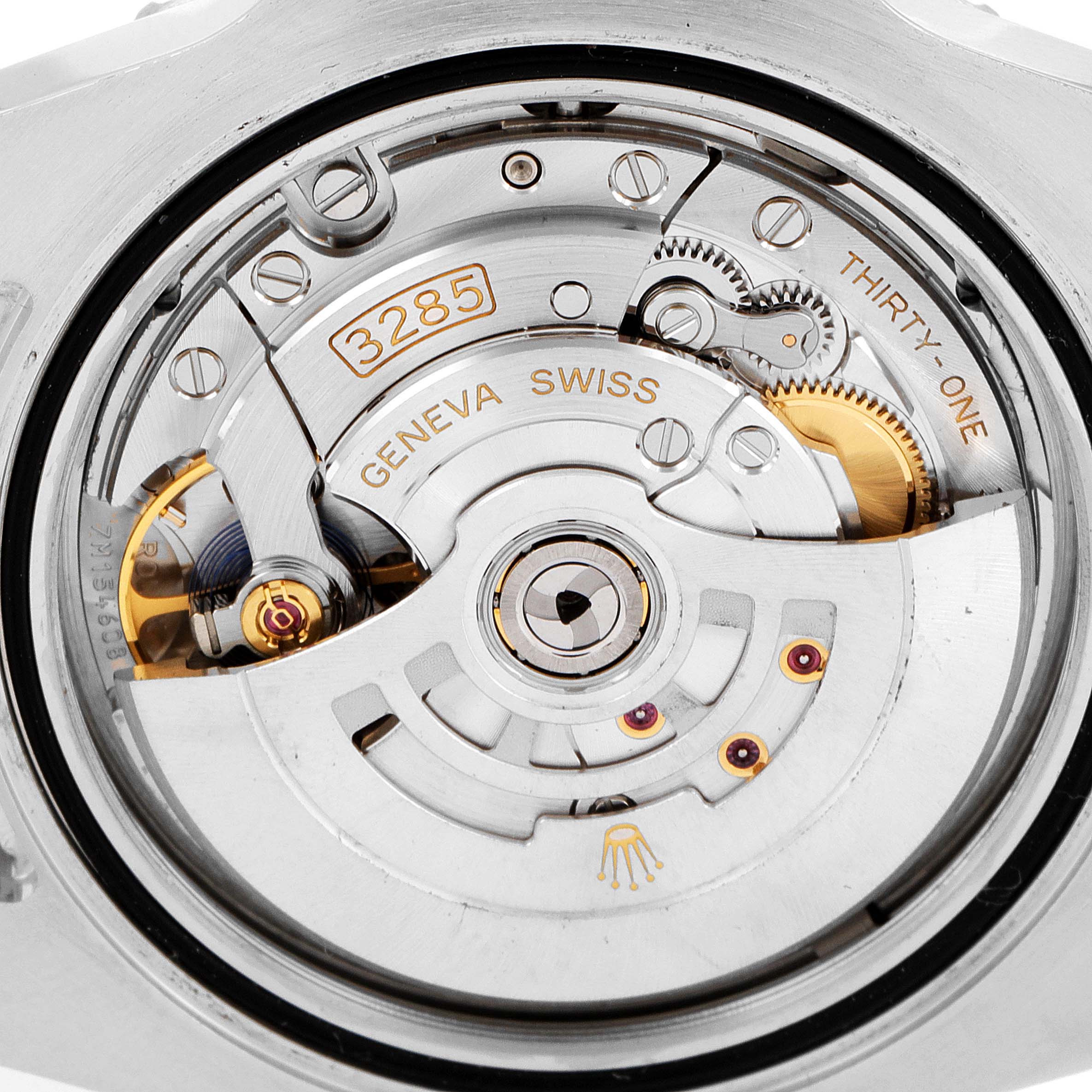 The image shows the movement of a Rolex GMT-Master 126711CHNR Men's Steel and Gold (two tone) Black Dial 126711CHNR Men's Steel and Gold (two tone) Black Dial watch from a close-up angle, highlighting its intricate internal mechanics.