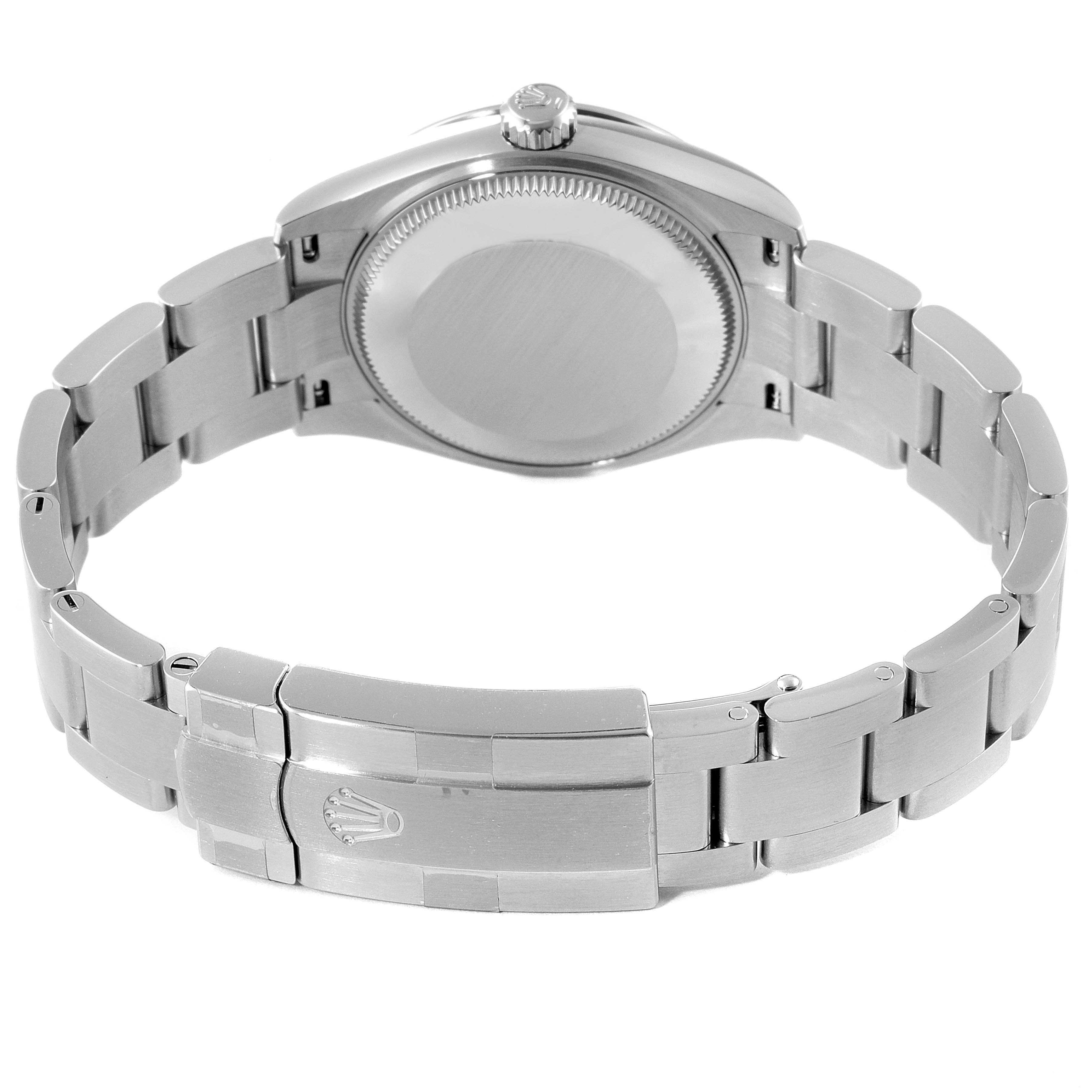 The image shows the back view of a mid-size Rolex watch, showcasing the clasp and the case back.