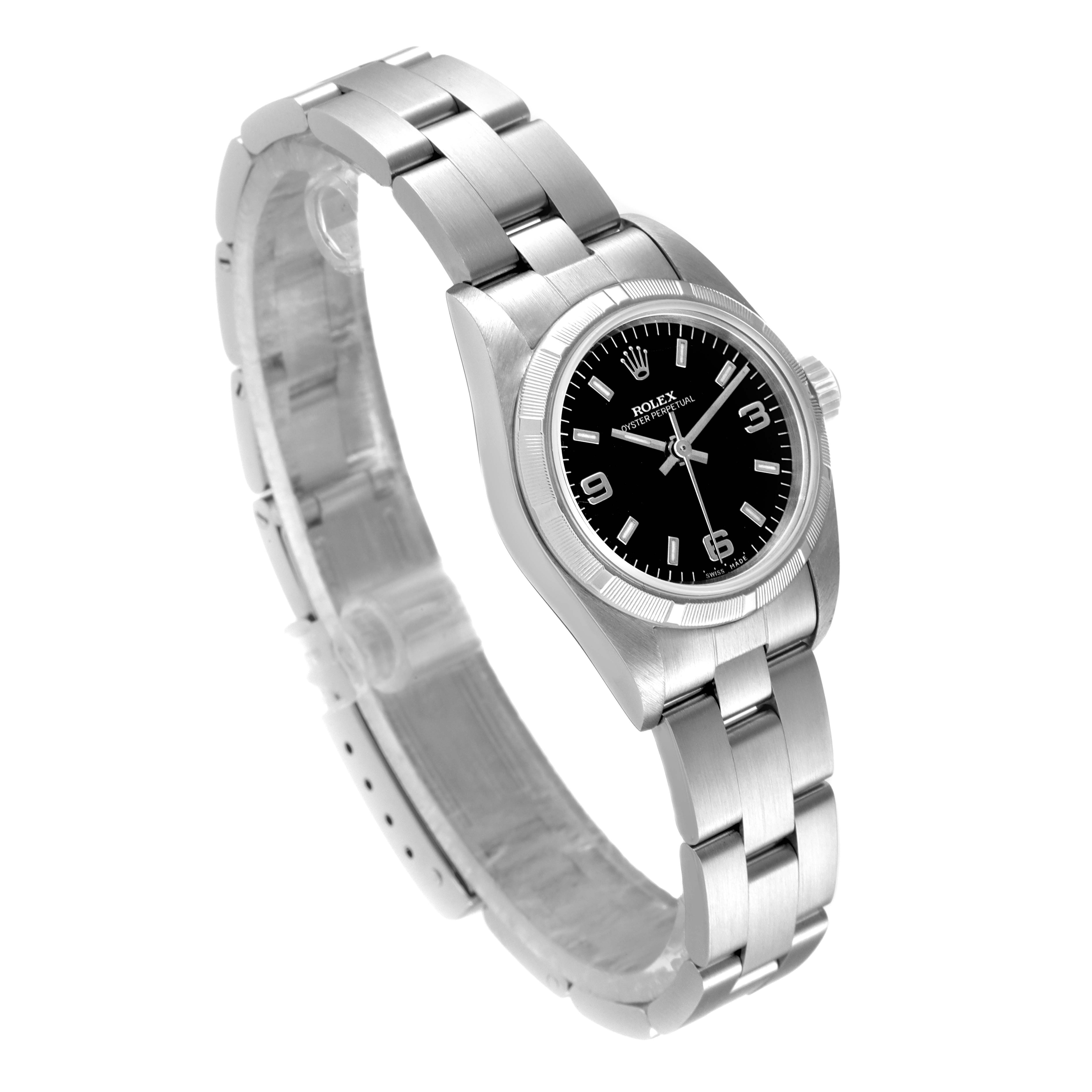 The image shows a side and front angle of a Rolex Oyster Perpetual 67230 Women's Stainless Steel Black Dial 67230 Women's Stainless Steel Black Dial watch, highlighting its stainless steel case and bracelet.