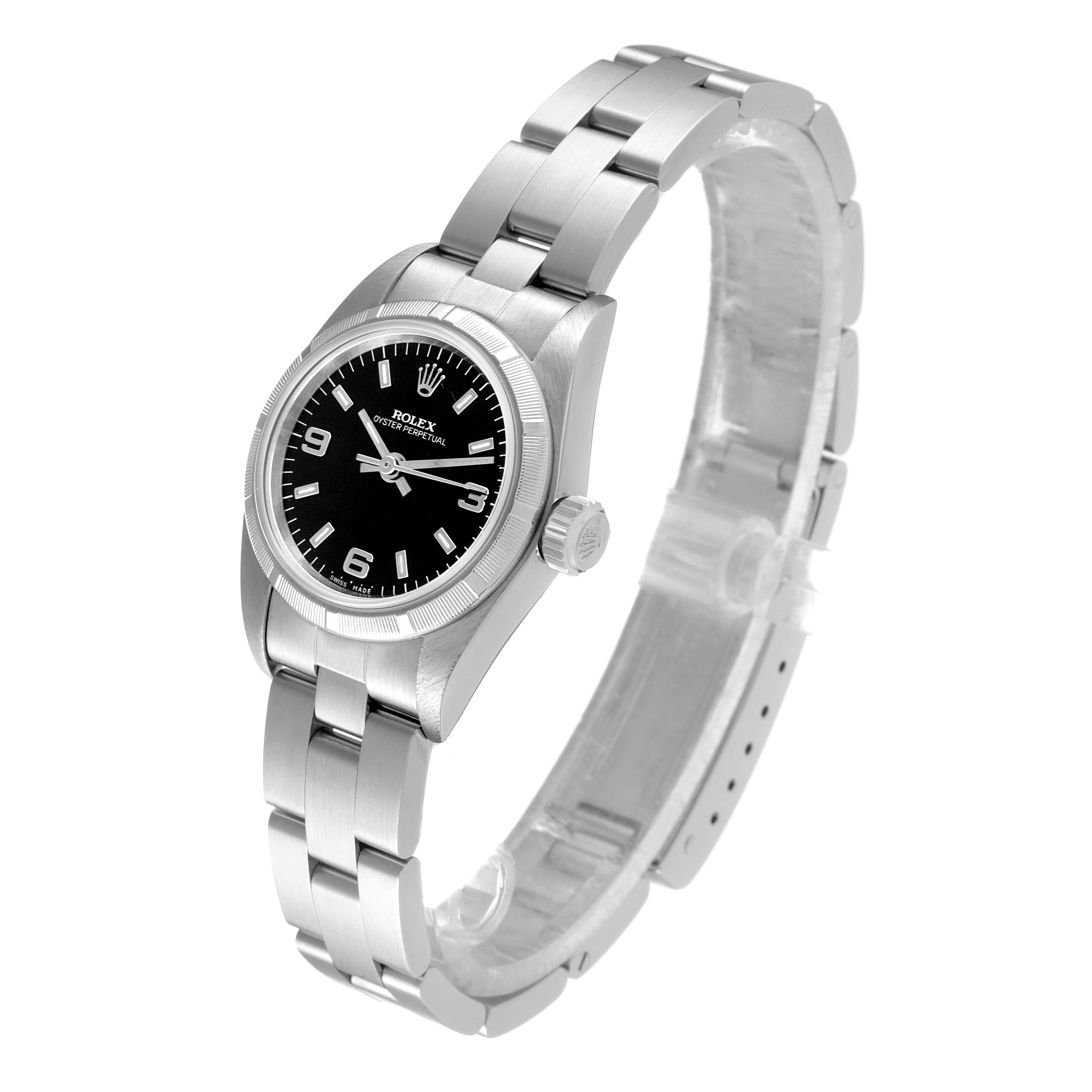 The Rolex Oyster Perpetual 67230 Women's Stainless Steel Black Dial 67230 Women's Stainless Steel Black Dial watch is shown from a three-quarter angle, displaying the face, bezel, case, and bracelet.