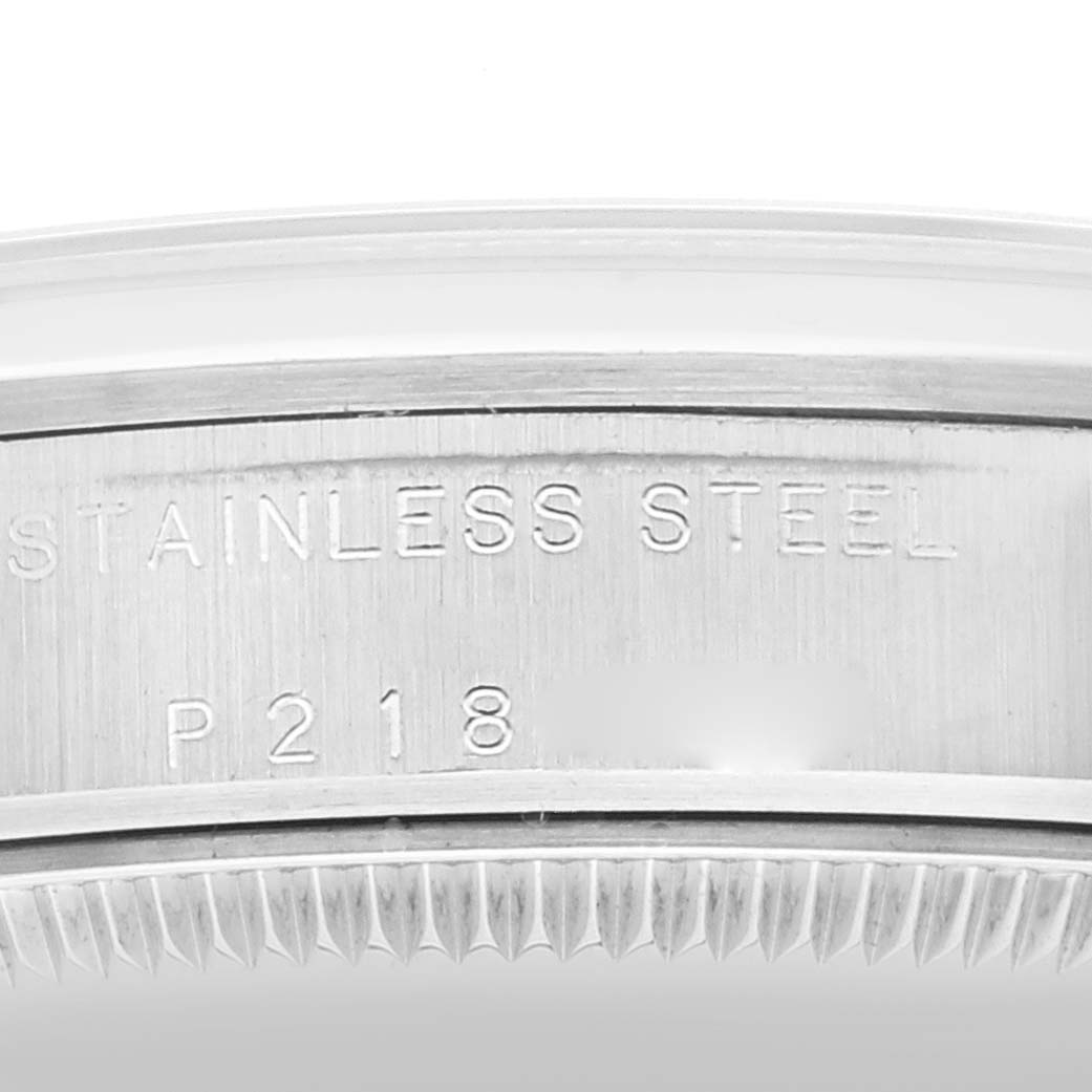 The image shows a close-up of the stainless steel case and serrated bezel of a Rolex Mid-Size 77080 Women
s Stainless Steel Blue Dial 77080 Women
s Stainless Steel Blue Dial watch.