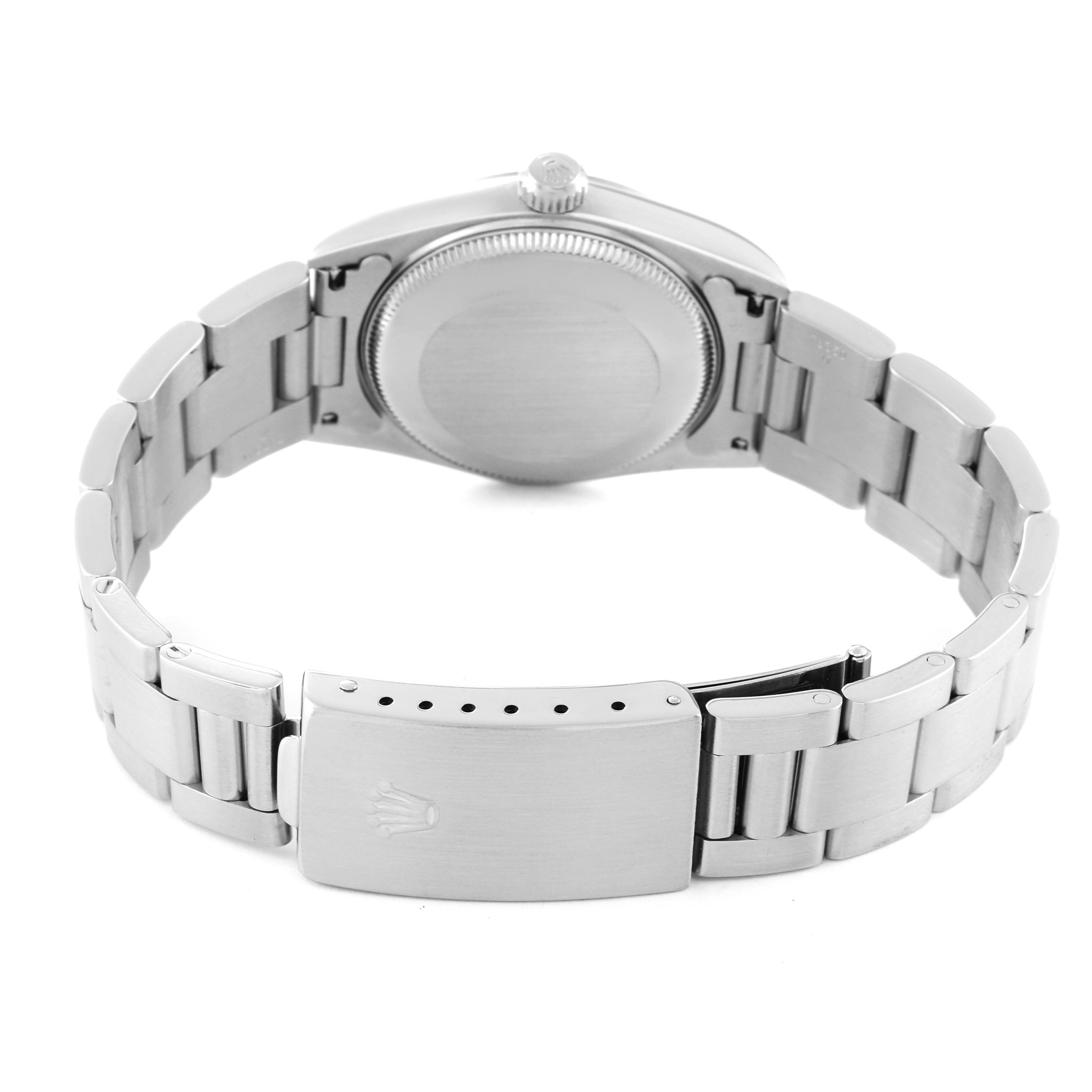 This image shows the back case and bracelet clasp of a mid-size Rolex watch from a rear, slightly elevated angle.