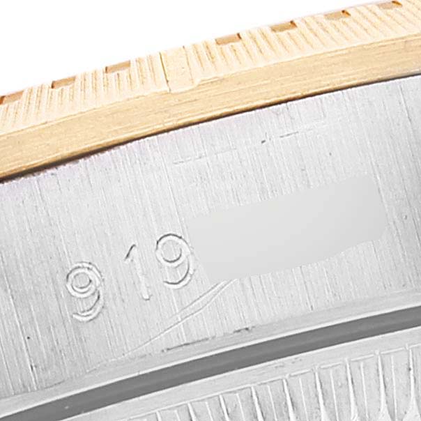 This image shows a close-up of the engraved bezel and edge of the Rolex Oyster Perpetual 67243 Women's Steel and Gold (two tone) Champagne Dial 67243 Women's Steel and Gold (two tone) Champagne Dial watch.