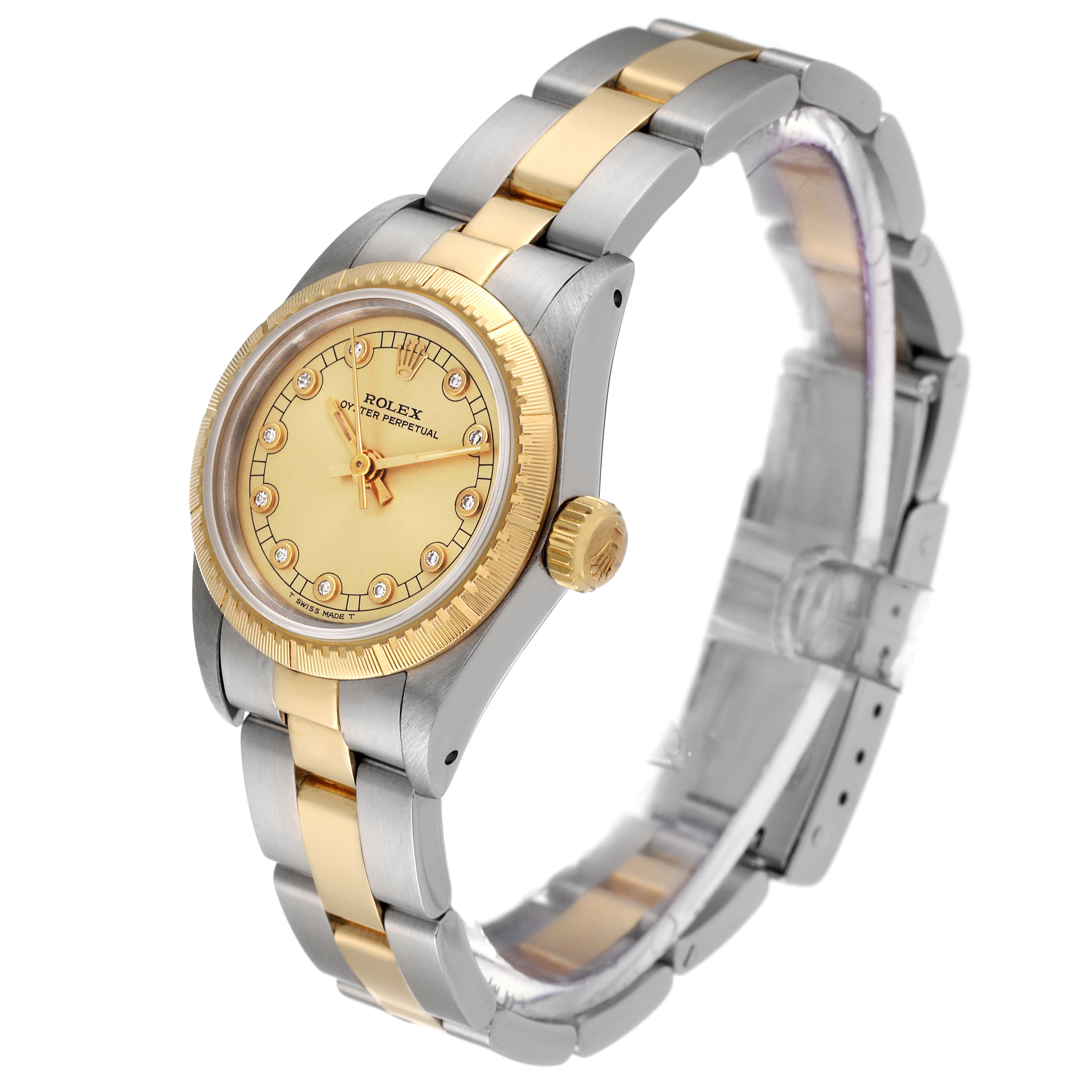 This image shows a Rolex Oyster Perpetual 67243 Women's Steel and Gold (two tone) Champagne Dial 67243 Women's Steel and Gold (two tone) Champagne Dial watch from a slightly elevated angle, displaying the face, bezel, crown, and bracelet.