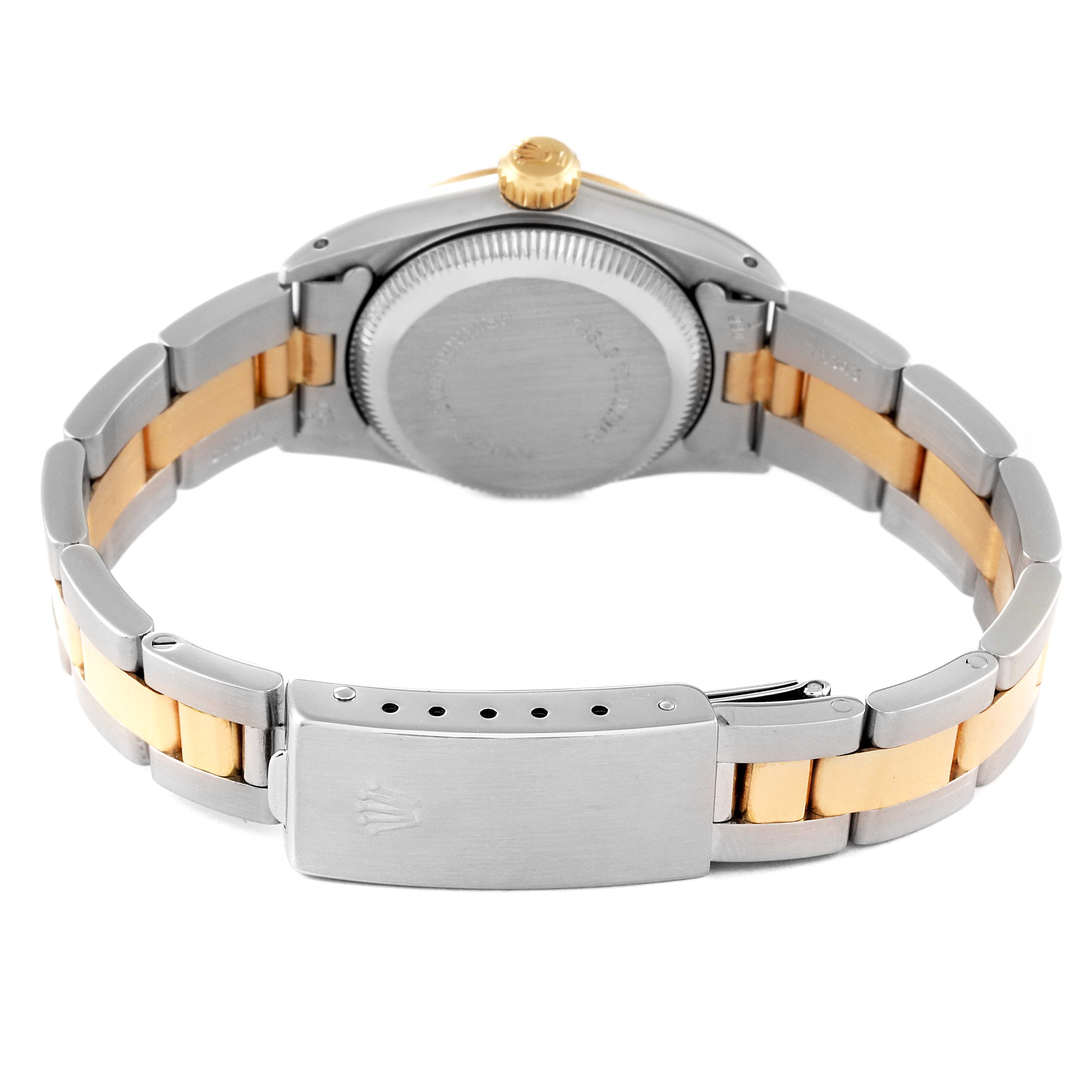 The image shows the back view of a Rolex Oyster Perpetual 67243 Women's Steel and Gold (two tone) Champagne Dial 67243 Women's Steel and Gold (two tone) Champagne Dial watch, highlighting its clasp, bracelet, and case back.