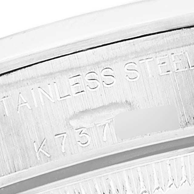 The image shows a close-up view of the serial number engraved on the stainless steel casing of a Rolex Oyster Perpetual 76080 Women's Stainless Steel Silver Dial 76080 Women's Stainless Steel Silver Dial watch.