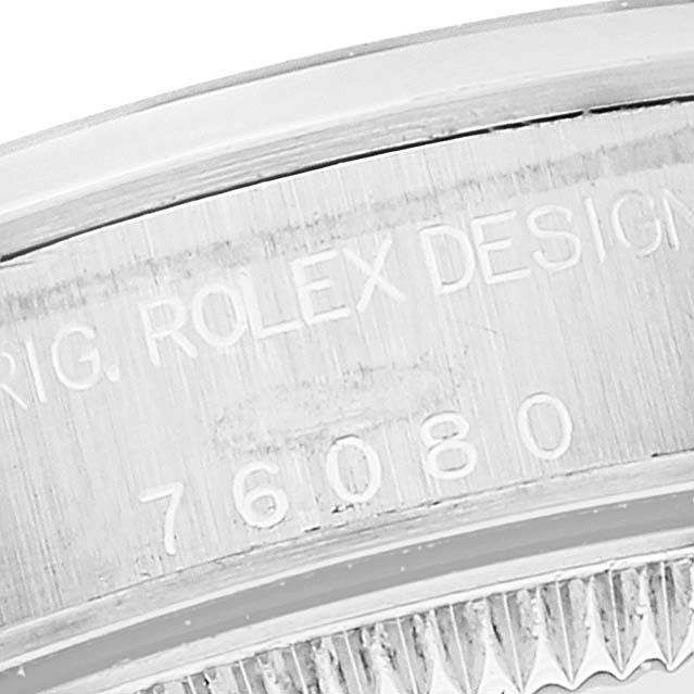 The image shows a close-up of the Rolex Oyster Perpetual 76080 Women's Stainless Steel Silver Dial 76080 Women's Stainless Steel Silver Dial's engraved case back, featuring the model number 76080.