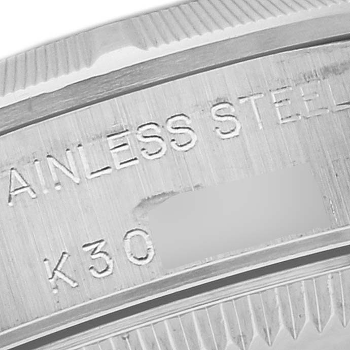 This image shows a close-up of the case back and edge of the bezel of a Rolex Oyster Perpetual 76030 Women's Stainless Steel Pink Dial 76030 Women's Stainless Steel Pink Dial watch, highlighting the engraving.