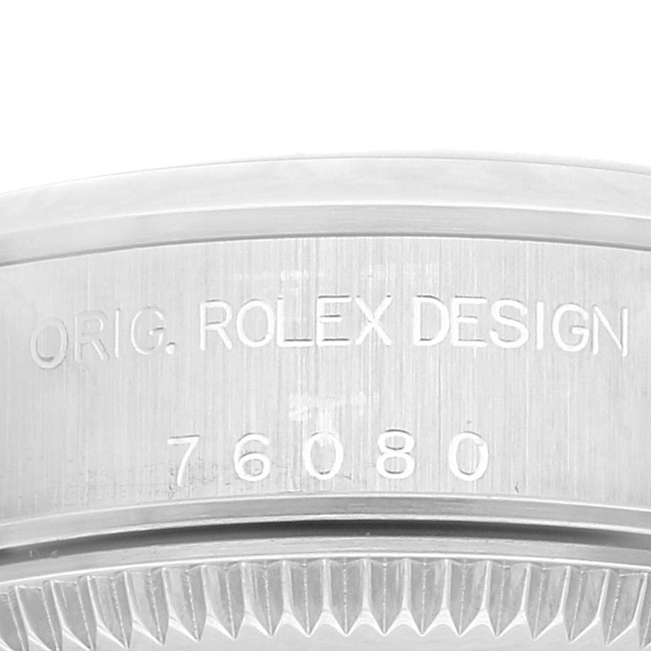 The image shows a close-up of the engraved case back of the Rolex Oyster Perpetual 76080 Women's Stainless Steel Pink Dial 76080 Women's Stainless Steel Pink Dial, revealing the model number 76080.