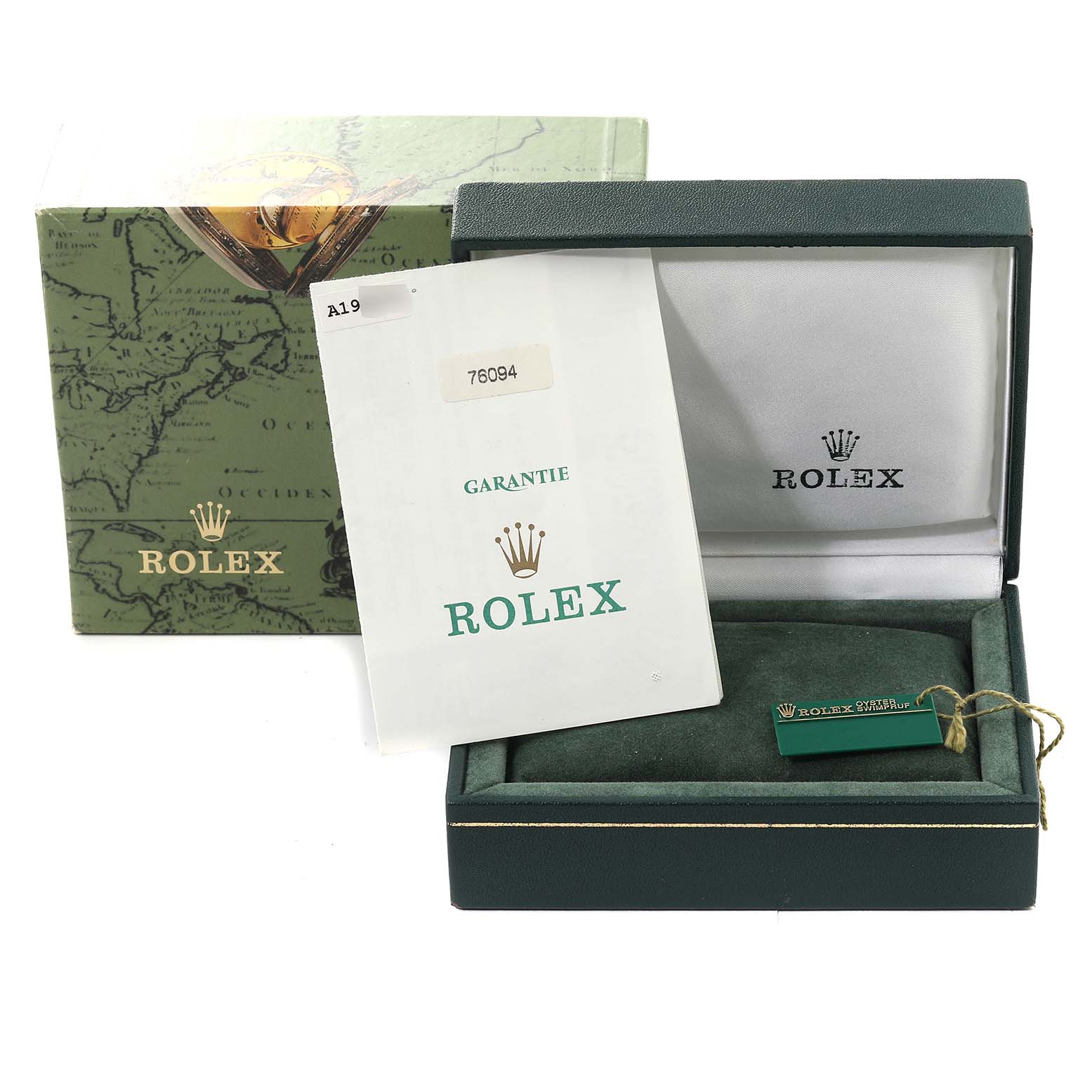 The image shows the packaging and accessories for a Rolex Oyster Perpetual 76094 Women's Stainless Steel Blue Dial 76094 Women's Stainless Steel Blue Dial, including the box, guarantee card, and a tag.