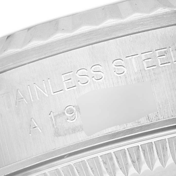 The image shows a close-up of the engraved bezel and inner ring of a Rolex Oyster Perpetual 76094 Women's Stainless Steel Blue Dial 76094 Women's Stainless Steel Blue Dial watch.
