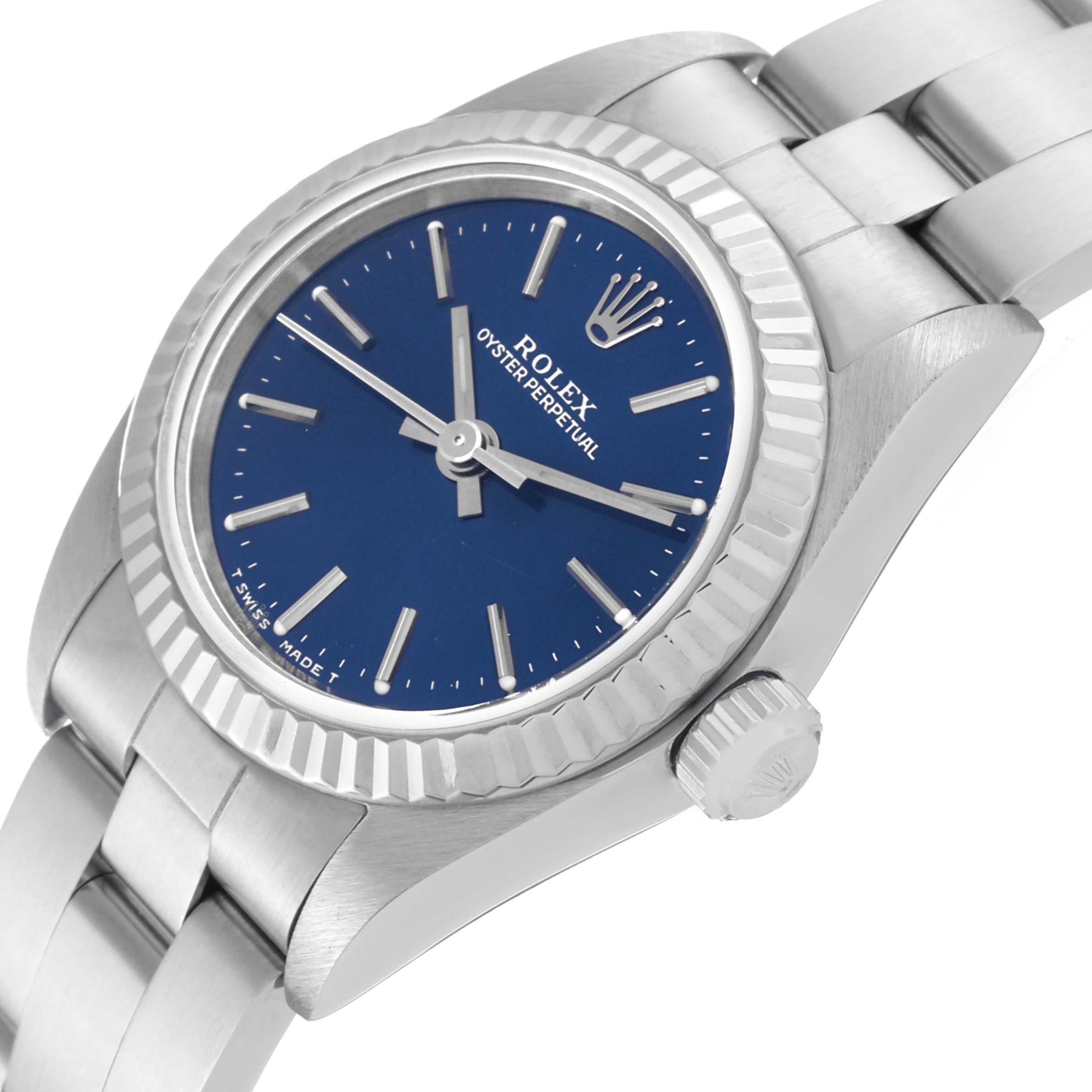 This image shows a close-up, angled view of the Rolex Oyster Perpetual 76094 Women's Stainless Steel Blue Dial 76094 Women's Stainless Steel Blue Dial watch, focusing on the blue dial, bezel, crown, and bracelet.