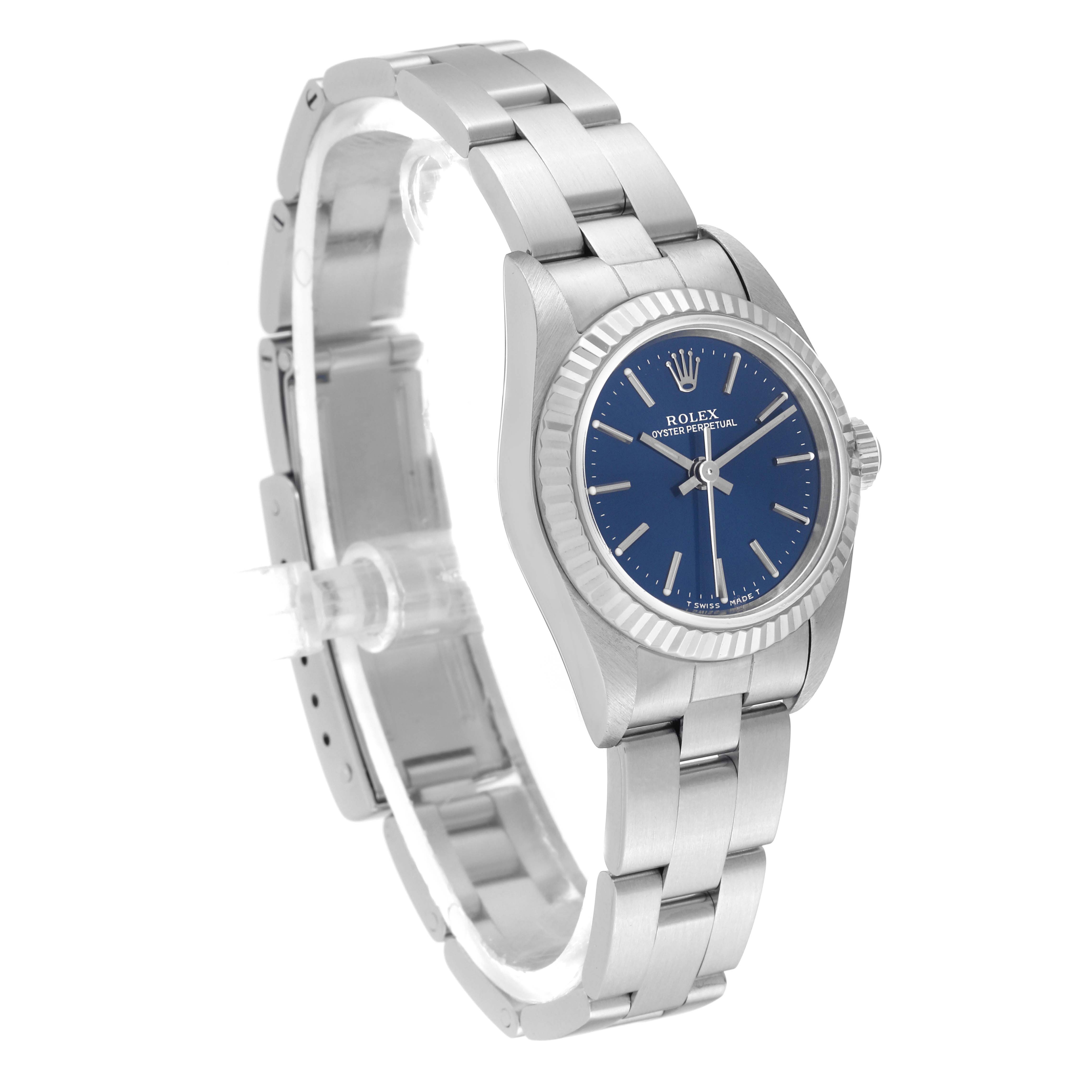 The Rolex Oyster Perpetual 76094 Women's Stainless Steel Blue Dial 76094 Women's Stainless Steel Blue Dial watch is shown at a three-quarter angle, displaying the face, bezel, and bracelet.