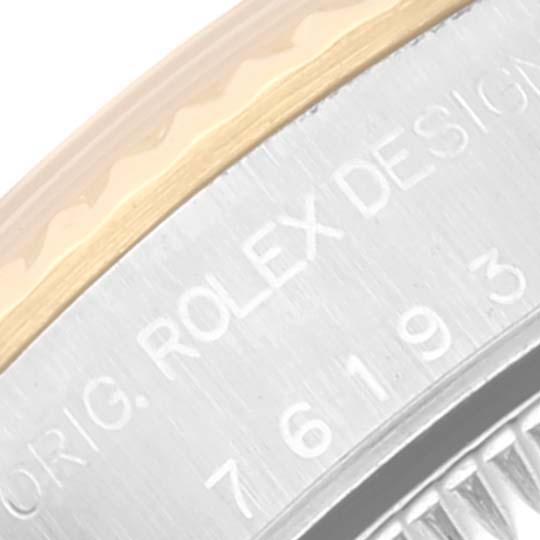 This close-up image of the Rolex Oyster Perpetual 76193 Women's Steel and Gold (two tone) Champagne Dial 76193 Women's Steel and Gold (two tone) Champagne Dial watch shows part of the case and the model number engraving.