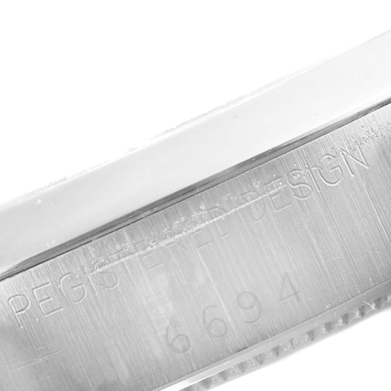 This image shows a close-up of the brushed metal case side and engraving on a Rolex Vintage Collection 6694 Men's Stainless Steel Black Dial 6694 Men's Stainless Steel Black Dial watch model number 6694.