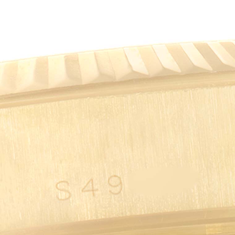 This close-up image shows a part of the bezel and case with serial number "S49" of a Rolex President 69178 Women
s Yellow Gold Champagne Dial 69178 Women
s Yellow Gold Champagne Dial model watch.