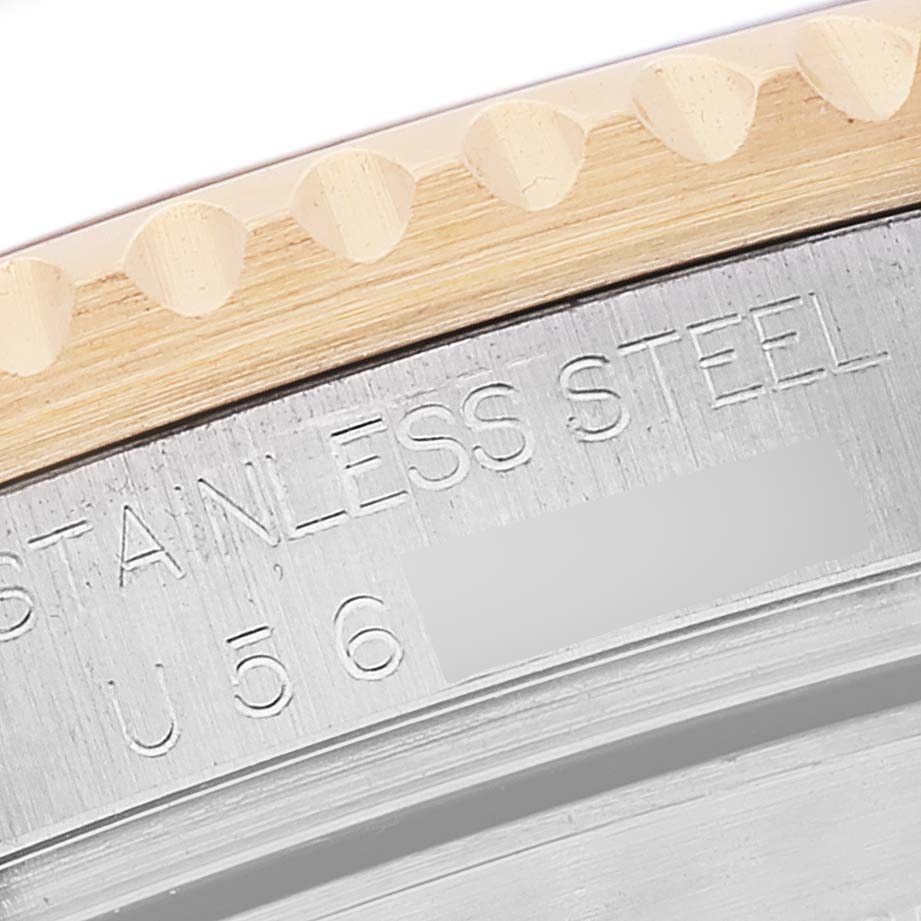 This close-up image shows the edge of the bezel and part of the stainless steel case of a Rolex Submariner 16613 Men's Steel and Gold (two tone) Grey Dial 16613 Men's Steel and Gold (two tone) Grey Dial watch.