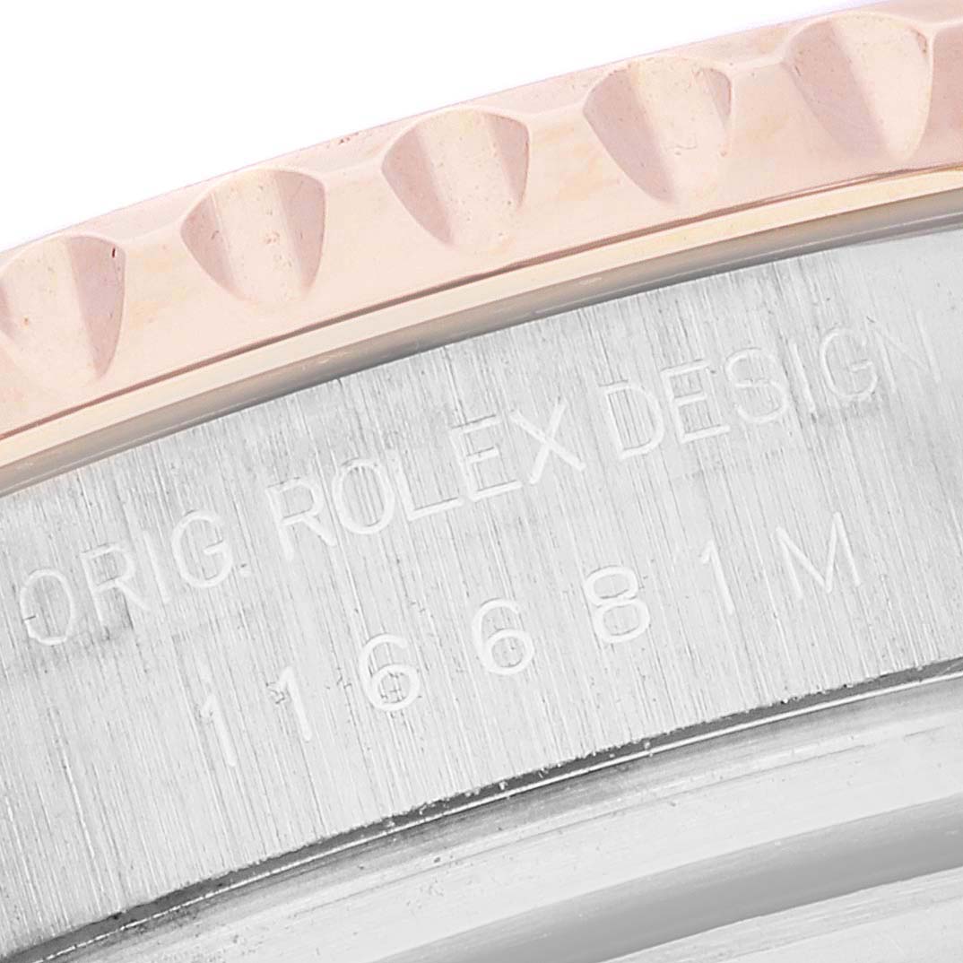 The image shows a close-up of the side engraving and part of the bezel of a Rolex Yacht-Master 116681 Men
s Steel and Gold (two tone) White Dial 116681 Men
s Steel and Gold (two tone) White Dial watch.