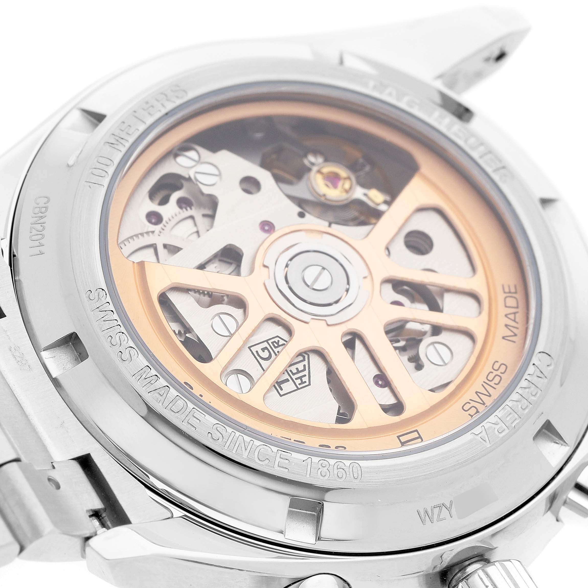 The image shows the back of a Tag Heuer Carrera CBN2011 Men's Stainless Steel Blue Dial watch, highlighting the exposed movement and rotor design.