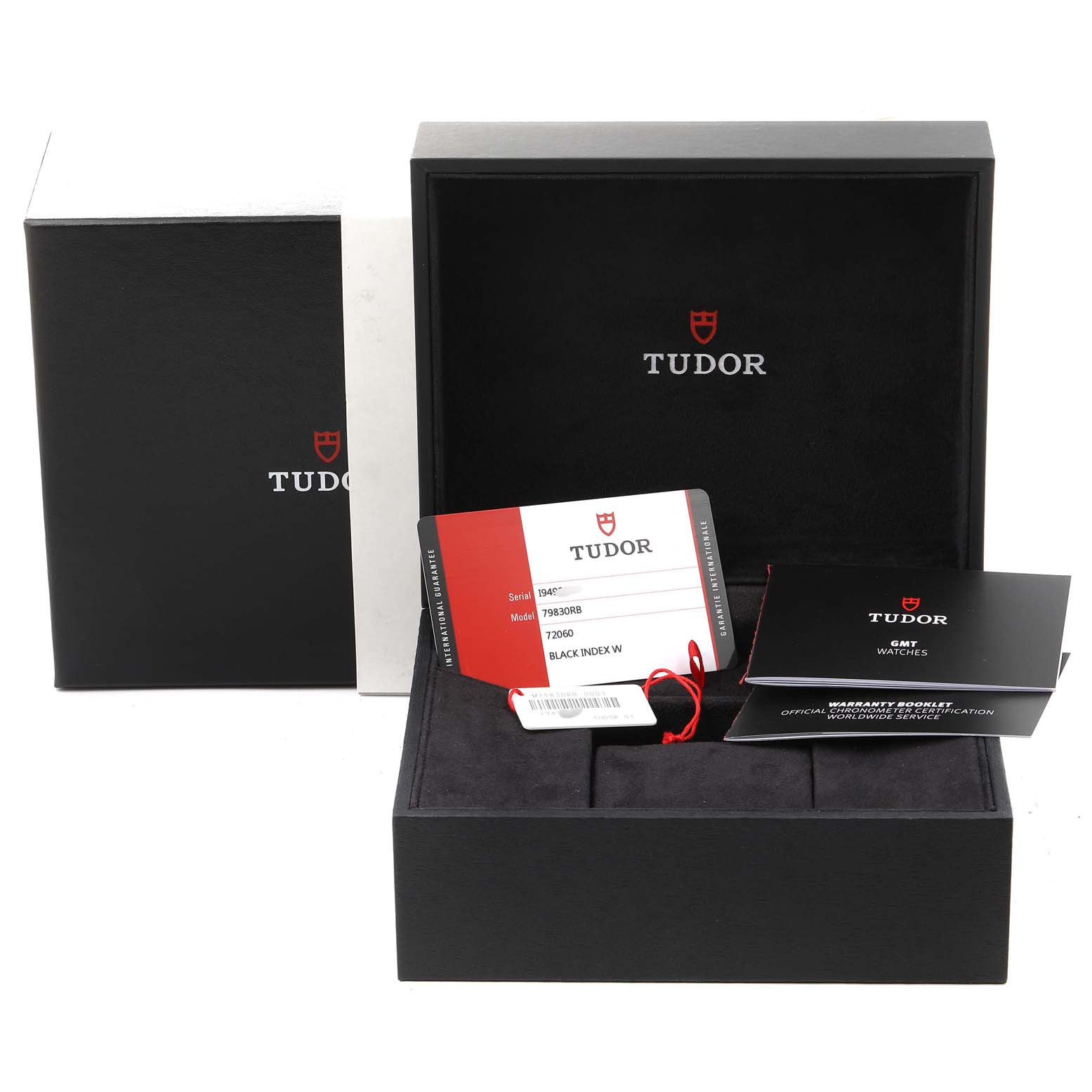 The image shows the packaging box, warranty card, and booklet for the Tudor Heritage Black Bay 79830RB Men's Stainless Steel Black Dial 79830RB Men's Stainless Steel Black Dial watch, all seen from a frontal view.
