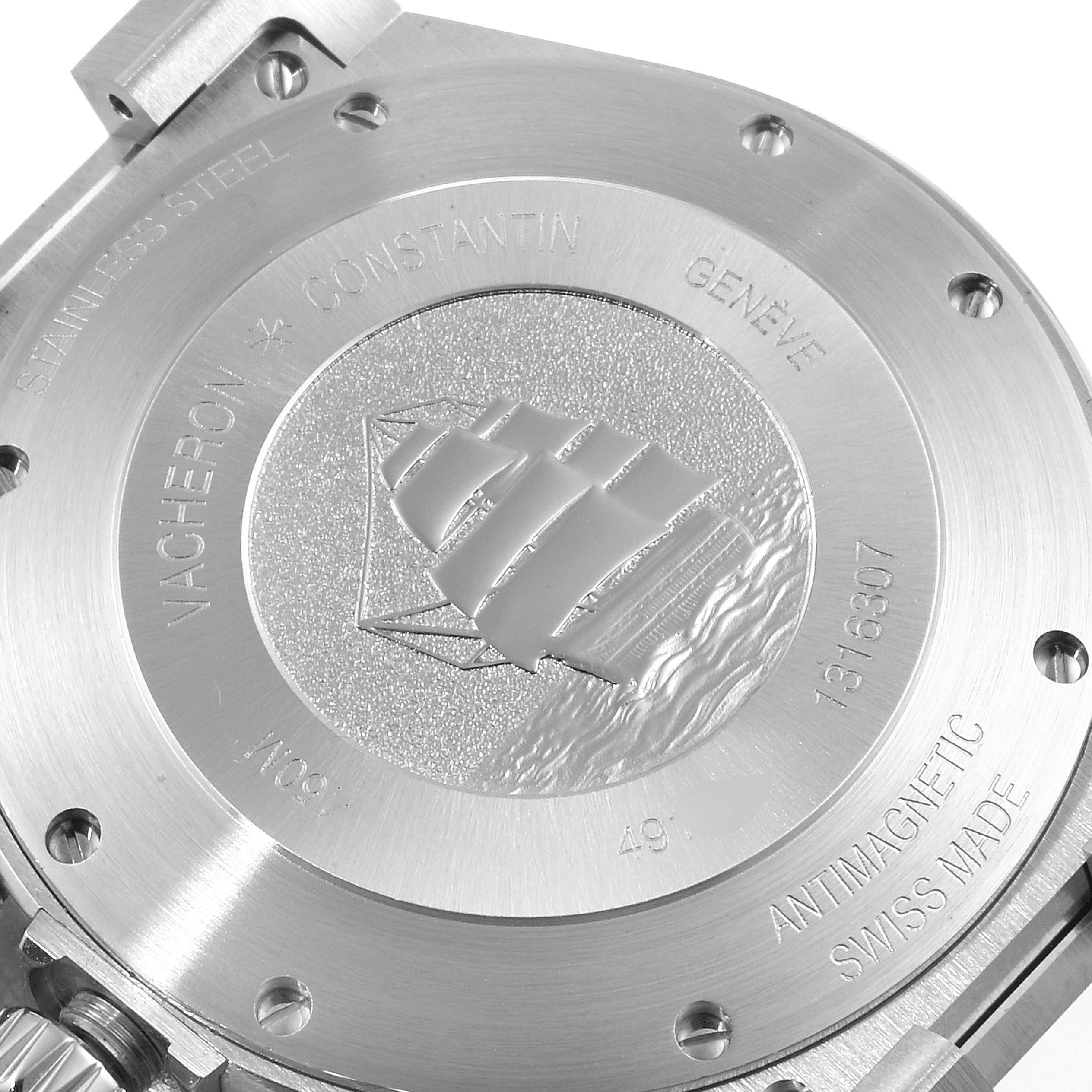 The image shows the case back of a Vacheron Constantin Overseas 49150.B01A.9097 Men's Stainless Steel Blue Dial 49150.B01A.9097 Men's Stainless Steel Blue Dial model, highlighting its engravings and emblem.