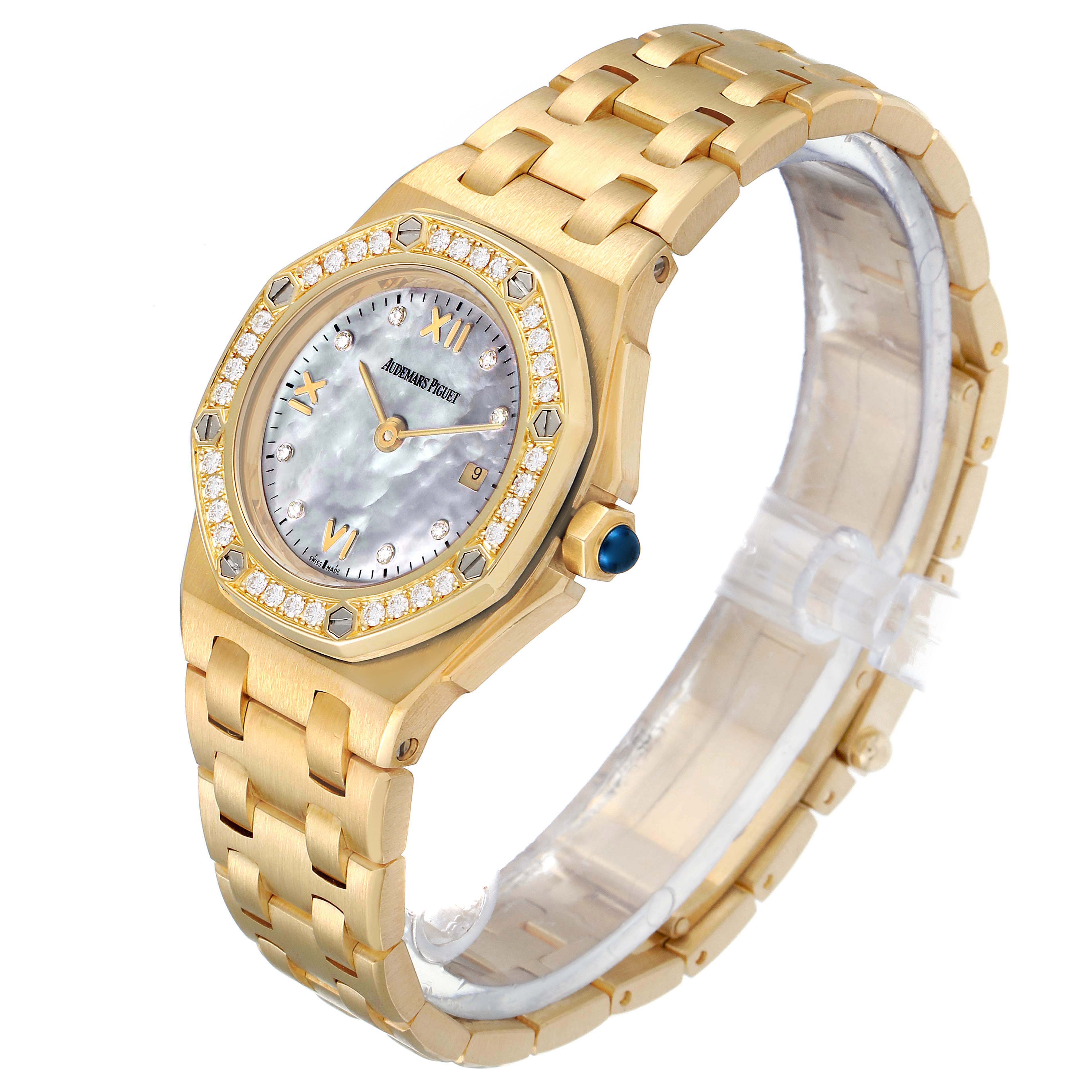 This image shows an angled view of an Audemars Piguet Royal Oak Offshore 67151BA.ZZ.1108BA.01 Women's Yellow Gold Mother of Pearl Dial 67151BA.ZZ.1108BA.01 Women's Yellow Gold Mother of Pearl Dial watch, highlighting its face, bezel, and bracelet.